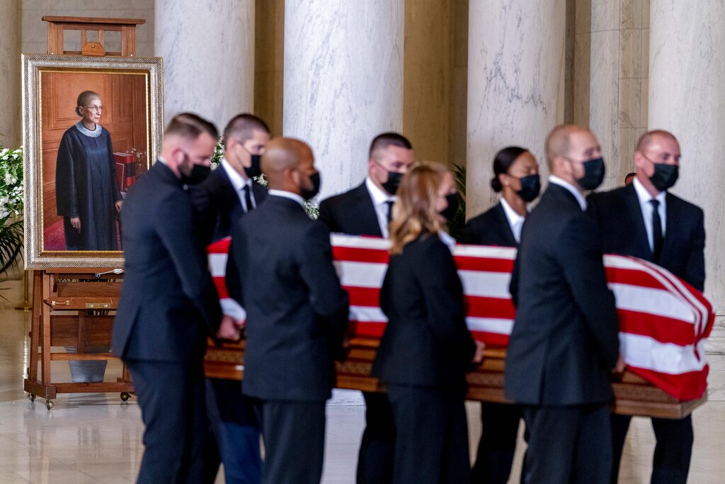 The flag-draped casket of Justice Ruth Bader Ginsburg, carried by Supreme Court police officers, arrives in the Great Hall at the Supreme Court in Washington, Wednesday, Sept. 23, 2020. Ginsburg, 87, died of cancer on Sept. 18. (AP Photo/Andrew Harnik, Pool)