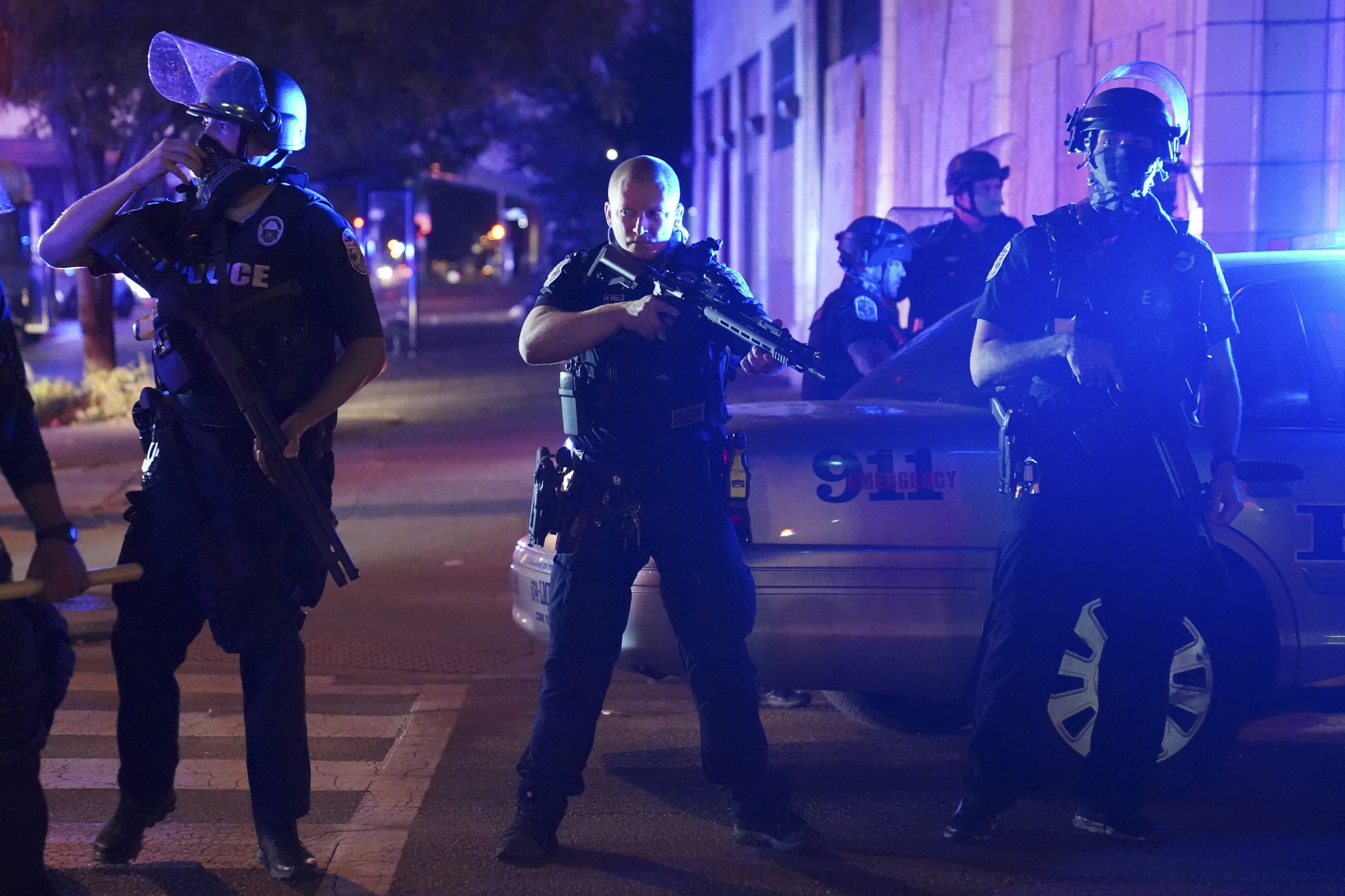 Police stand at an intersection after an officer was shot Sept. 23, 2020, in Louisville, Kentucky. (John Minchillo / Associated Press)