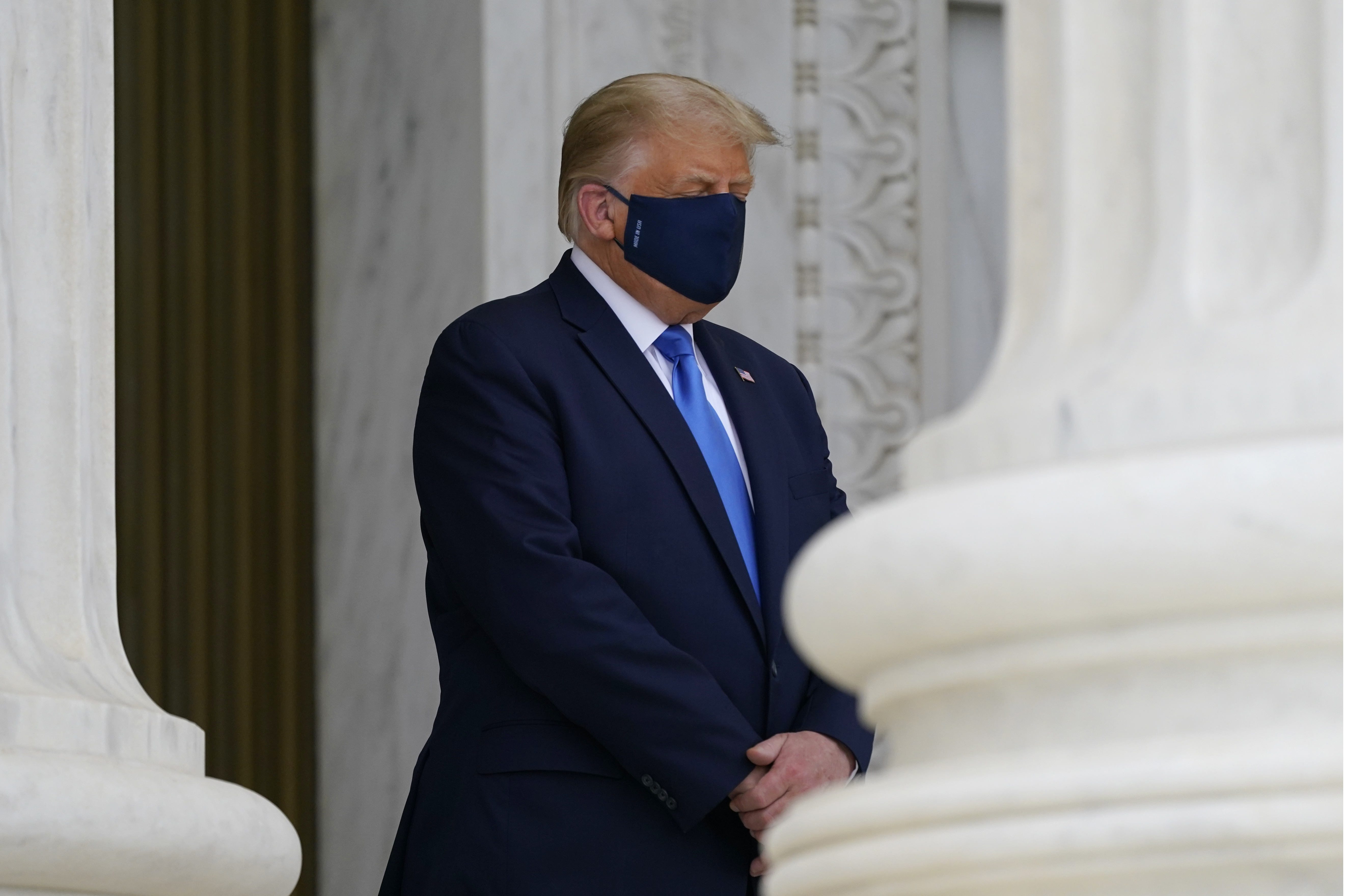 President Donald Trump pays respects as Justice Ruth Bader Ginsburg lies in repose under the Portico at the top of the front steps of the U.S. Supreme Court building on Thursday, Sept. 24 2020, in Washington. Ginsburg, 87, died of cancer on Sept. 18. (AP Photo/Alex Brandon, Pool)