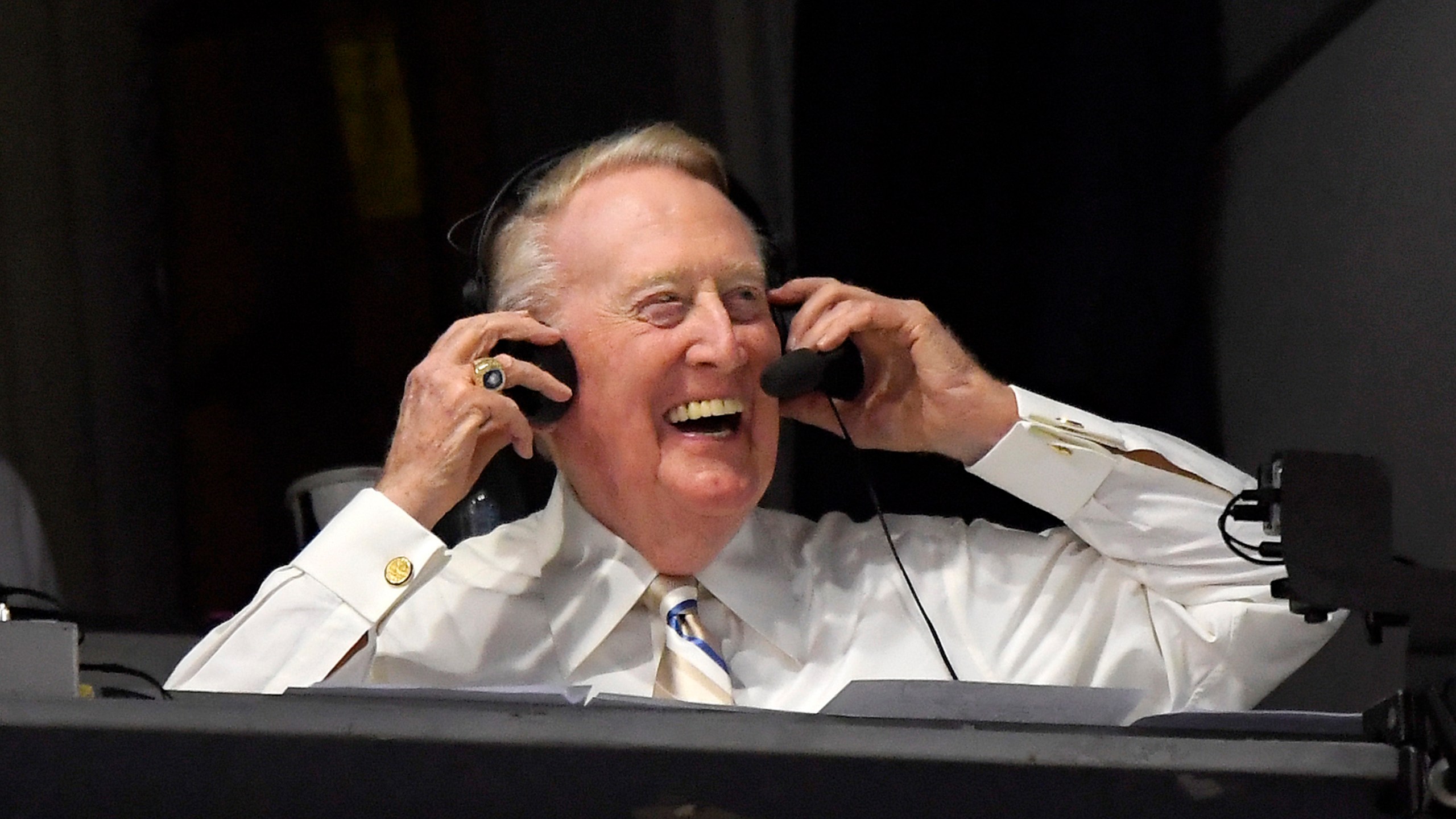 In this Sept. 19, 2016, file photo, Los Angeles Dodgers Hall of Fame announcer Vin Scully puts his headset on prior to a baseball game between the Dodgers and the San Francisco Giants in Los Angeles. (AP Photo/Mark J. Terrill, File)