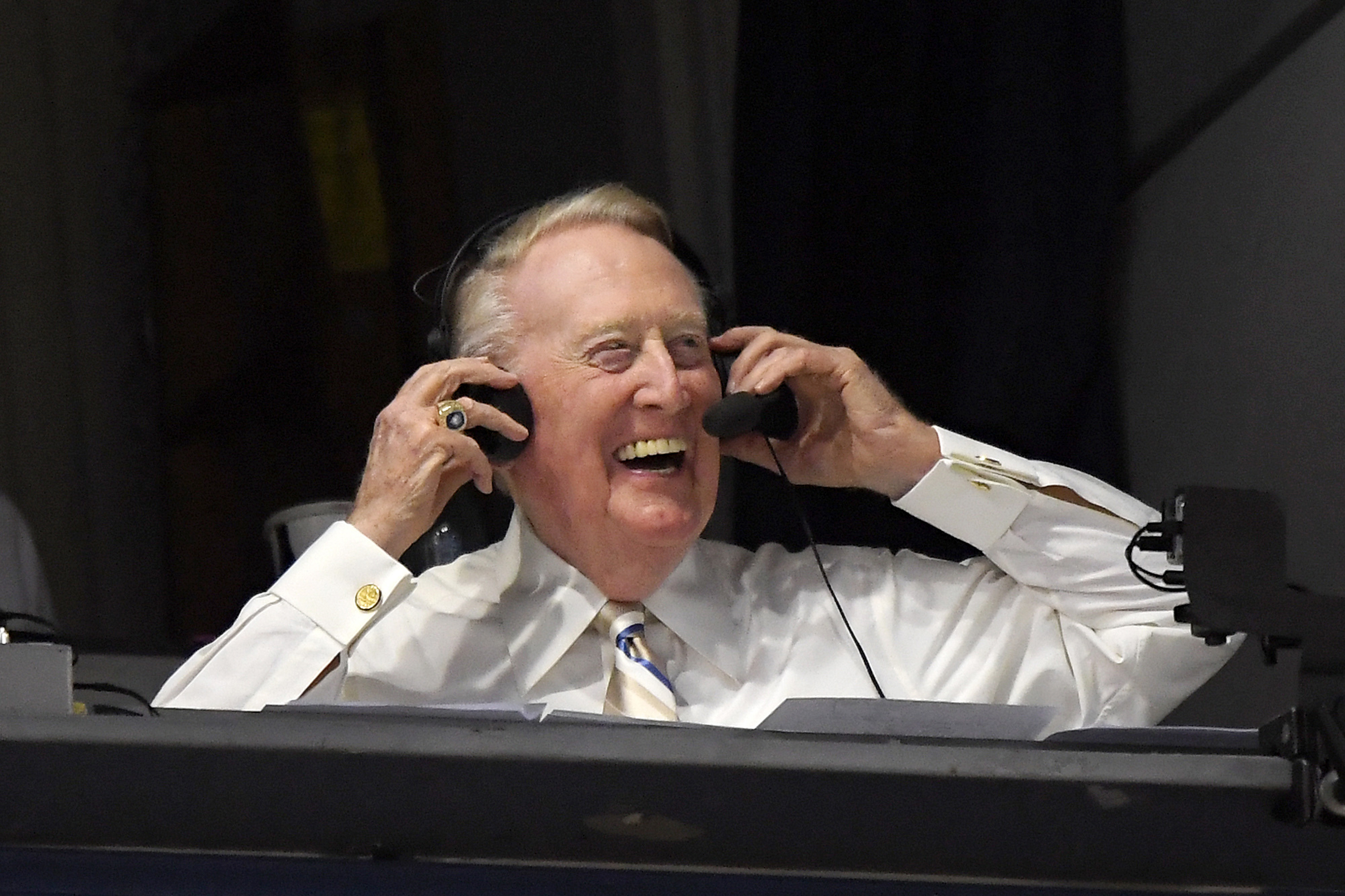 In this Sept. 19, 2016, file photo, Los Angeles Dodgers Hall of Fame announcer Vin Scully puts his headset on prior to a baseball game between the Dodgers and the San Francisco Giants in Los Angeles. (AP Photo/Mark J. Terrill, File)