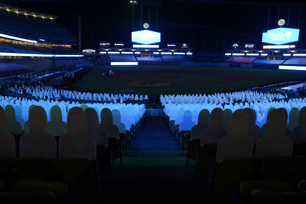 Players leave the field after a power outage during the seventh inning of a baseball game between the Los Angeles Angels and the Los Angeles Dodgers Sept. 26, 2020, in Los Angeles. (AP Photo/Ashley Landis)