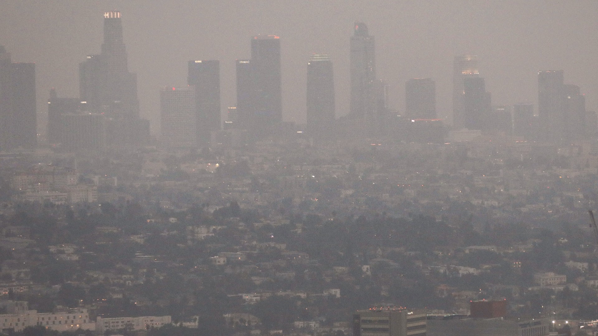 The downtown skyline is partially obscured by smoke from wildfires after sunset as a helicopter passes on September 13, 2020 in Los Angeles, California. Air quality was deemed ’unhealthy for sensitive groups’ in the metropolitan area today as California's national forests remain closed due to wildfires which have already incinerated a record 2.3 million acres this year. (Mario Tama/Getty Images)