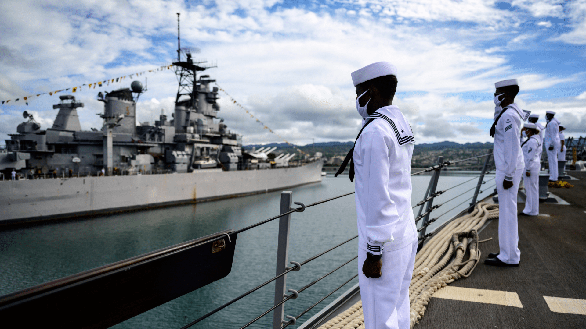 Sailors aboard the guided-missile destroyer USS Michael Murphy (DDG 112) render honors to Battleship Missouri Memorial during the official ceremony for the 75th anniversary of the Japanese surrender that ended World War II, Wednesday, Sept. 2, 2020, in Honolulu, Hawaii. (Petty Officer 1st Class Devin Langer/U.S. Navy via AP)