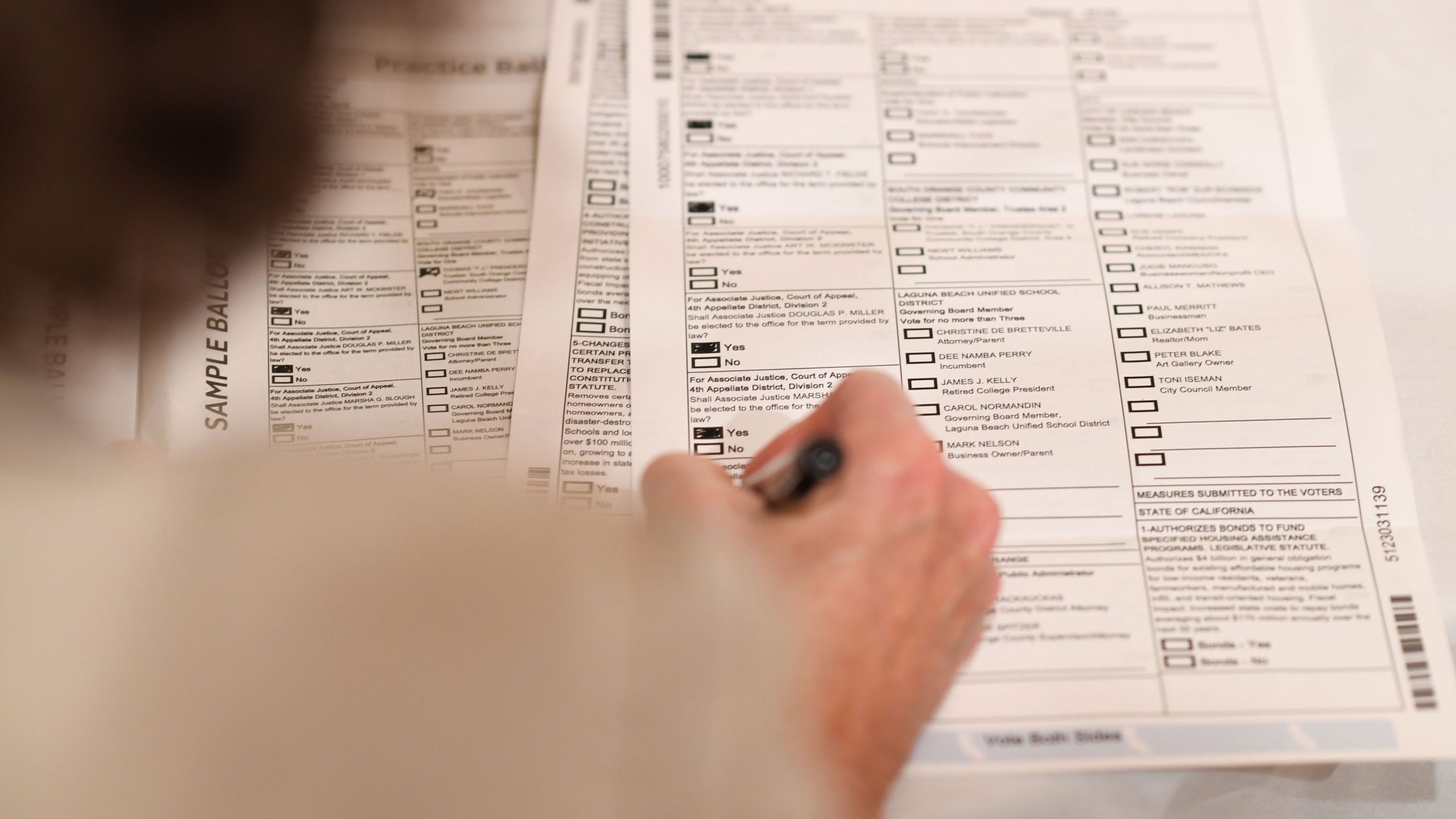 A voter completes her mail-in ballot at home in Laguna Niguel on Oct. 24, 2018. (Robyn Beck / AFP / Getty Images)