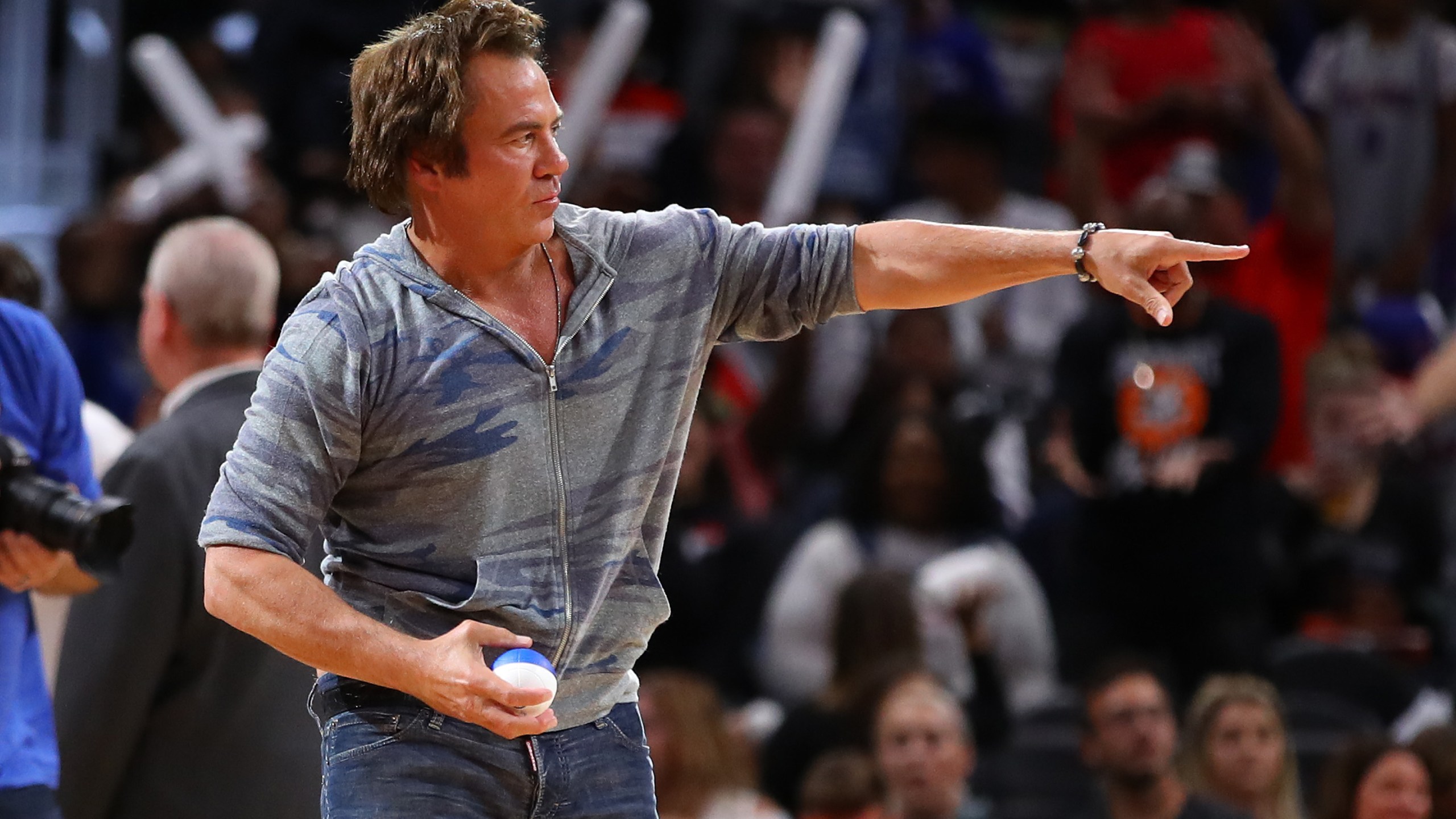 Owner of the Detroit Pistons Tom Gores throws a miniature basketball to fans during a pre-season game between the Orlando Magic and the Detroit Pistons at Little Caesars Arena in Detroit on Oct. 7, 2019. (Gregory Shamus / Getty Images)