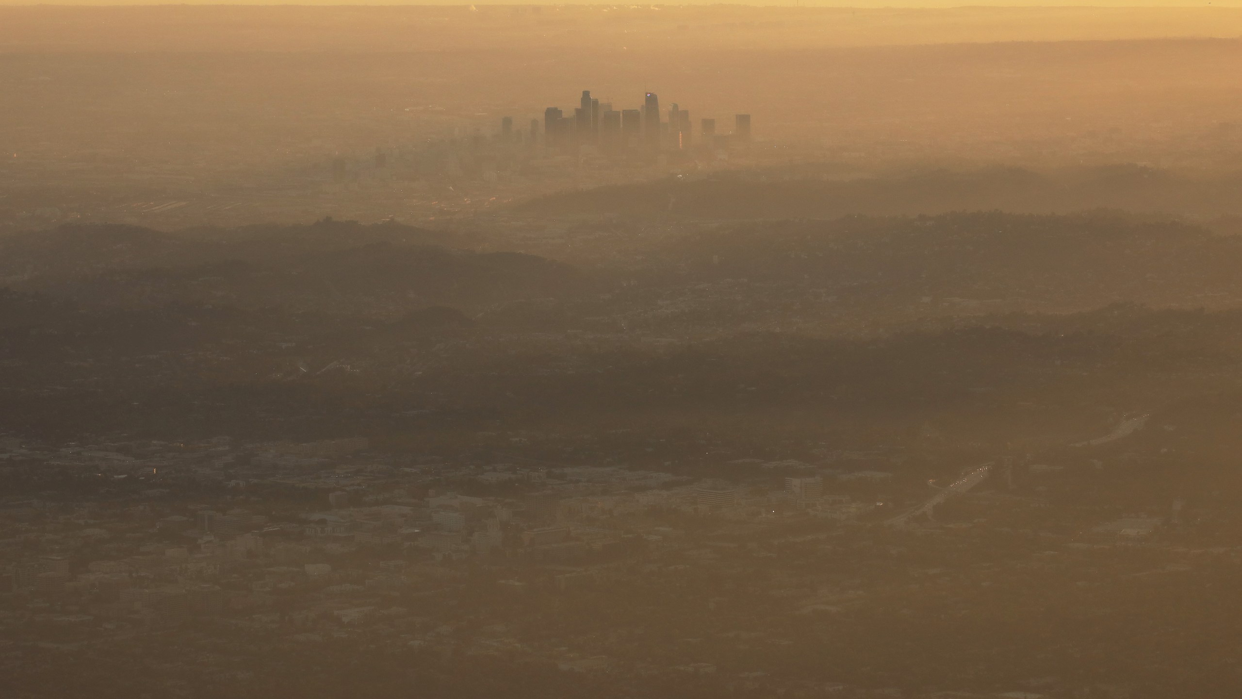 The buildings of downtown Los Angeles are partially obscured in the late afternoon on Nov. 5, 2019 as seen from Pasadena. The air quality for metropolitan Los Angeles was predicted to be "unhealthy for sensitive groups" that day by the South Coast Air Quality Management District. The Trump administration has begun officially withdrawing from the Paris Climate Agreement. A new report by more than 11,000 scientists worldwide states that the planet "clearly and unequivocally faces a climate emergency." (Mario Tama/Getty Images)