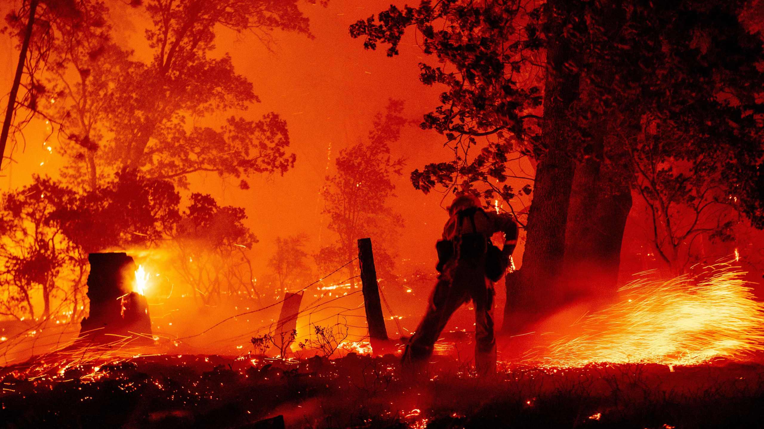 A firefighter works the line as flames push towards homes during the Creek fire in the Cascadel Woods area of unincorporated Madera County, California on September 7, 2020. (Photo by JOSH EDELSON/AFP via Getty Images)