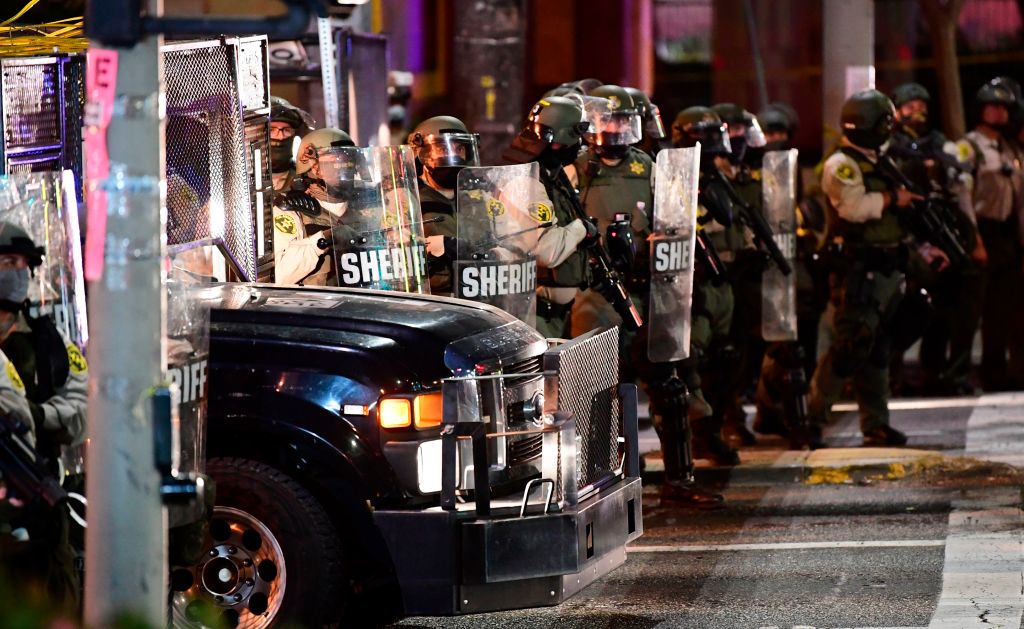 Los Angeles County sheriff's deputies move in to disperse a crowd of demonstrators gathered to protest again in the wake of Dijon Kizzee's killing, outside the South L.A. sheriff's station on Sept. 8, 2020 in Los Angeles, California. (FREDERIC J. BROWN/AFP via Getty Images)