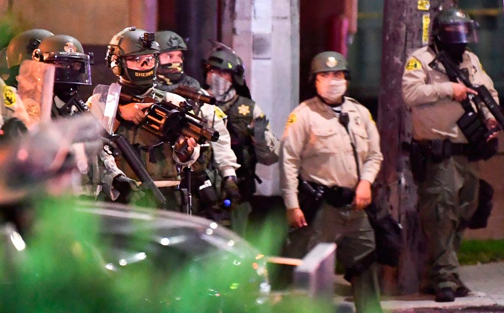 Los Angeles County sheriff's deputies move in to disperse a crowd of demonstrators gathered to protest again in the wake of Dijon Kizzee's killing, outside the South L.A. sheriff's station on Sept. 8, 2020 in Los Angeles, California. (FREDERIC J. BROWN/AFP via Getty Images)