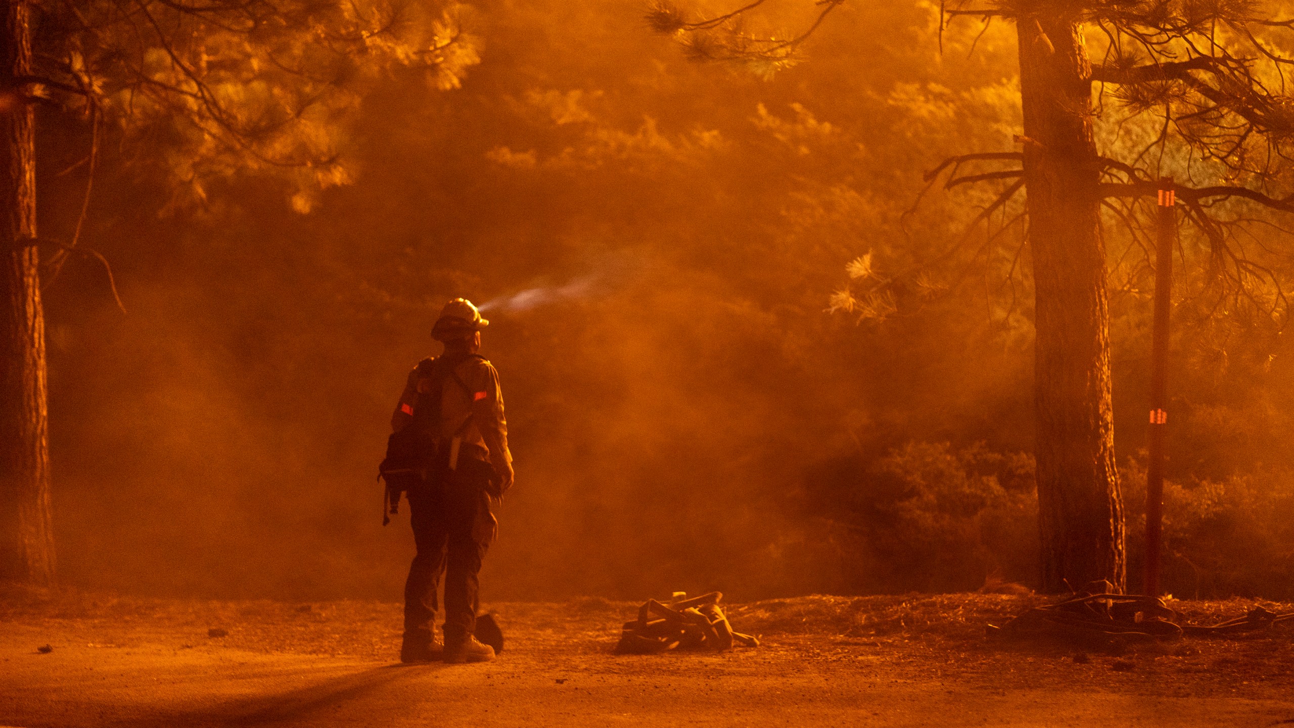 A firefighter keeps watch on flames that could jump the Angeles Crest Highway at the Bobcat Fire in the Angeles National Forest on Sept. 11, 2020 north of Monrovia, Calif. (David McNew/Getty Images)