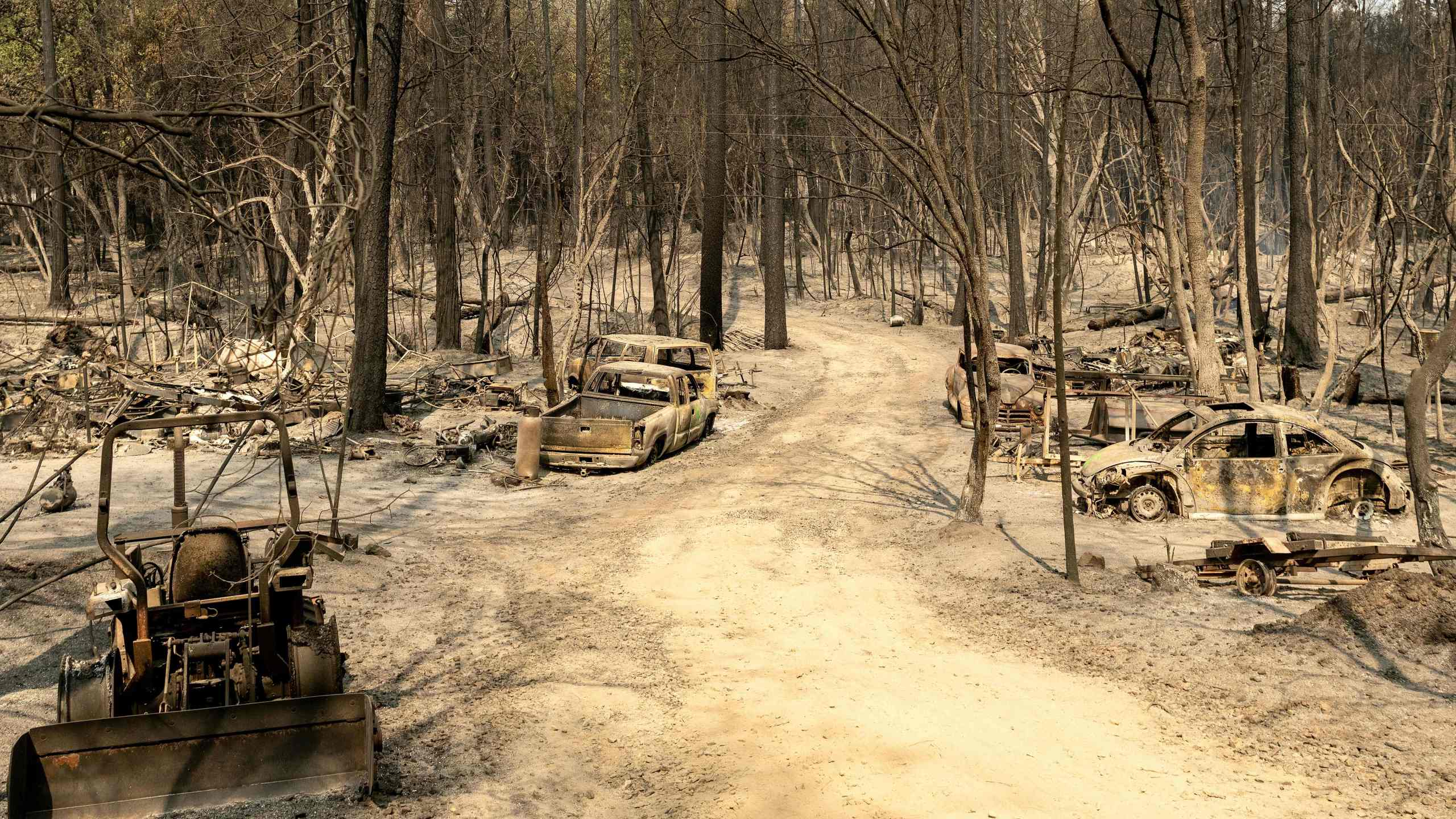 A residential area smolders during the Bear Fire, part of the larger North Lightning Complex Fire, in the Berry Creek area of unincorporated Butte County on Sept. 14, 2020. (Josh Edelson / AFP / Getty Images)