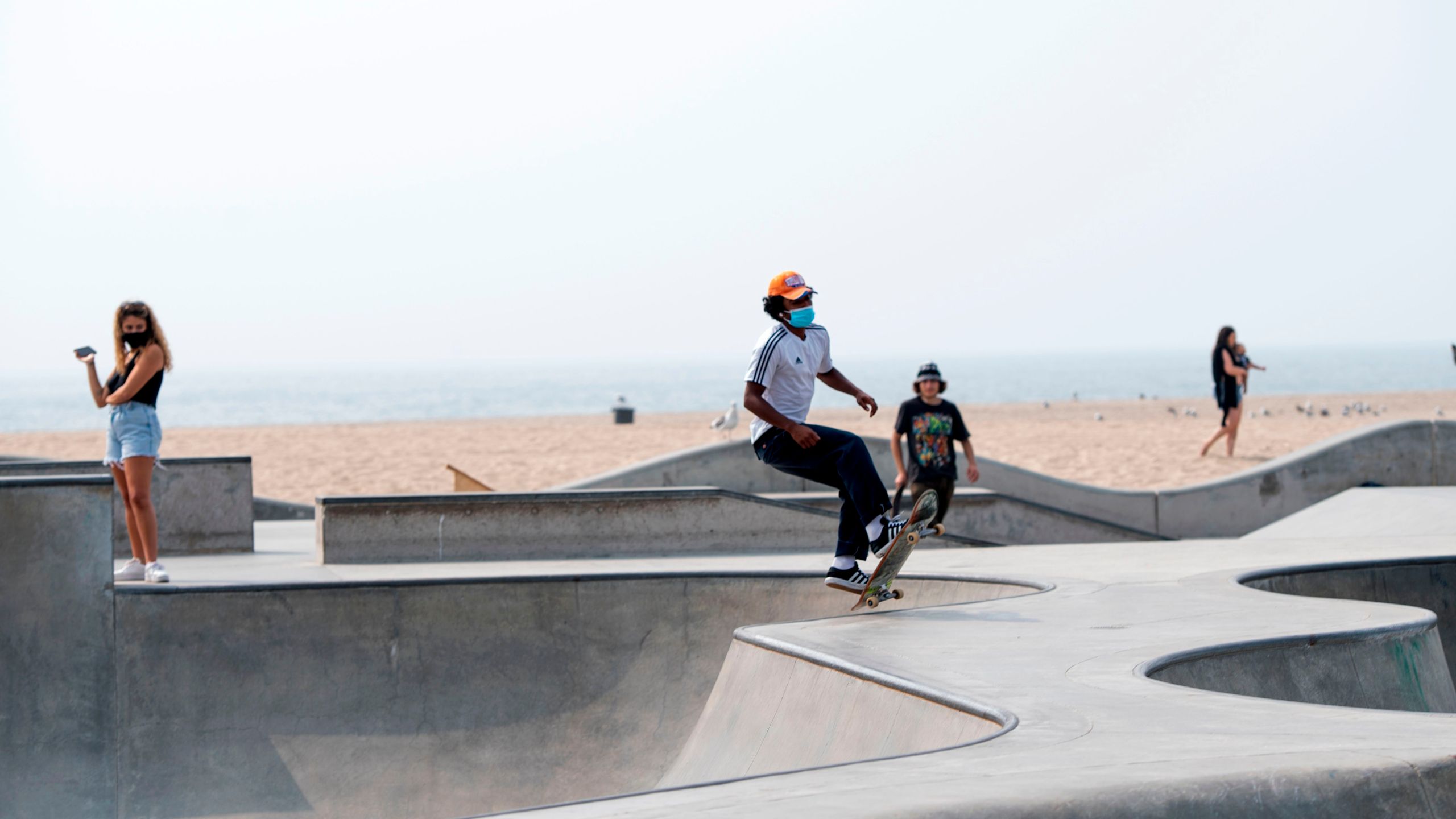 A man wearing a face mask skateboards at a skate park in Venice Beach on Sept. 15, 2020. (VALERIE MACON/AFP via Getty Images)