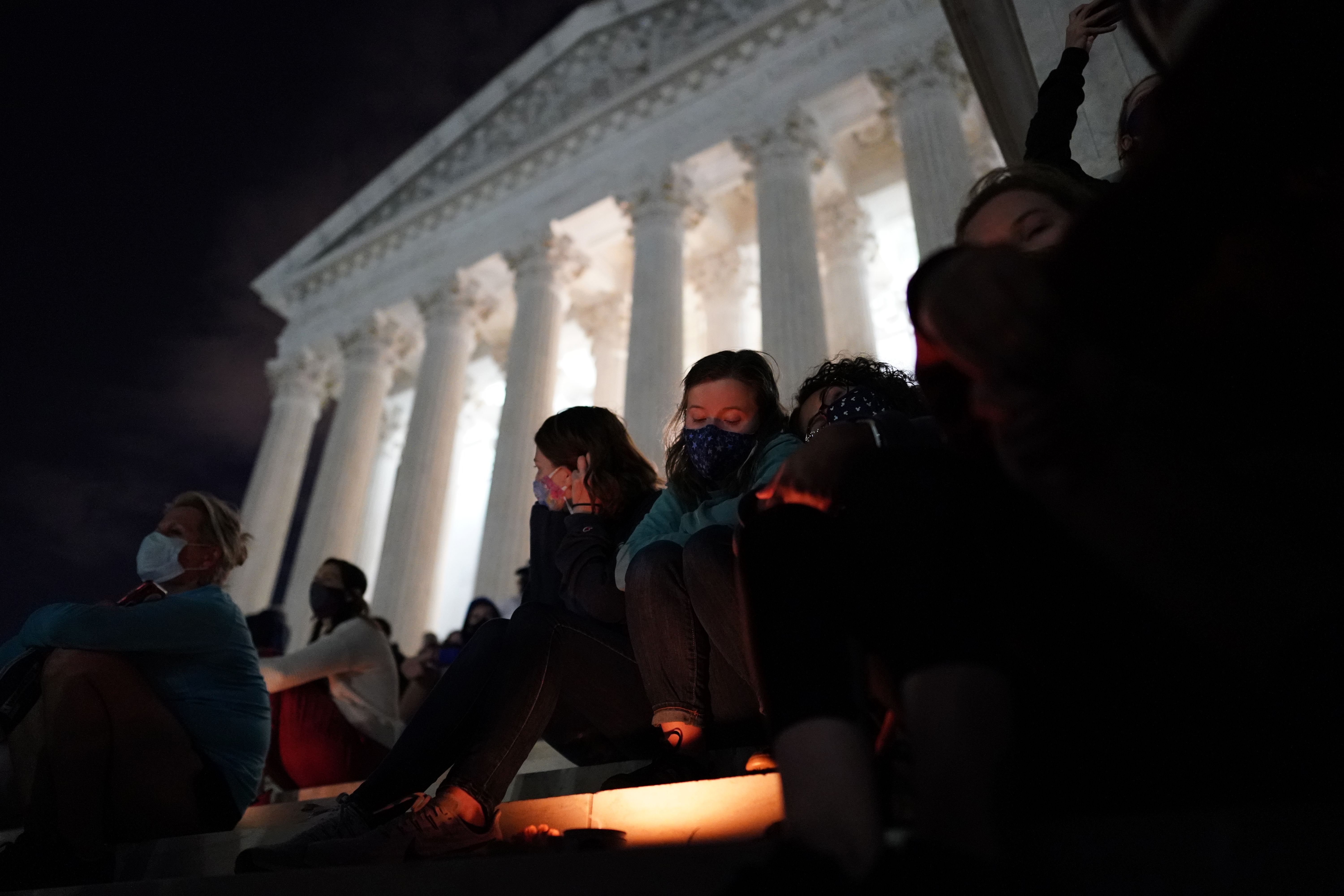 People gather at a makeshift memorial for late Justice Ruth Bader Ginsburg on the steps of the Supreme Court building on Sept. 18, 2020. (Alex Edelman / AFP / Getty Images)