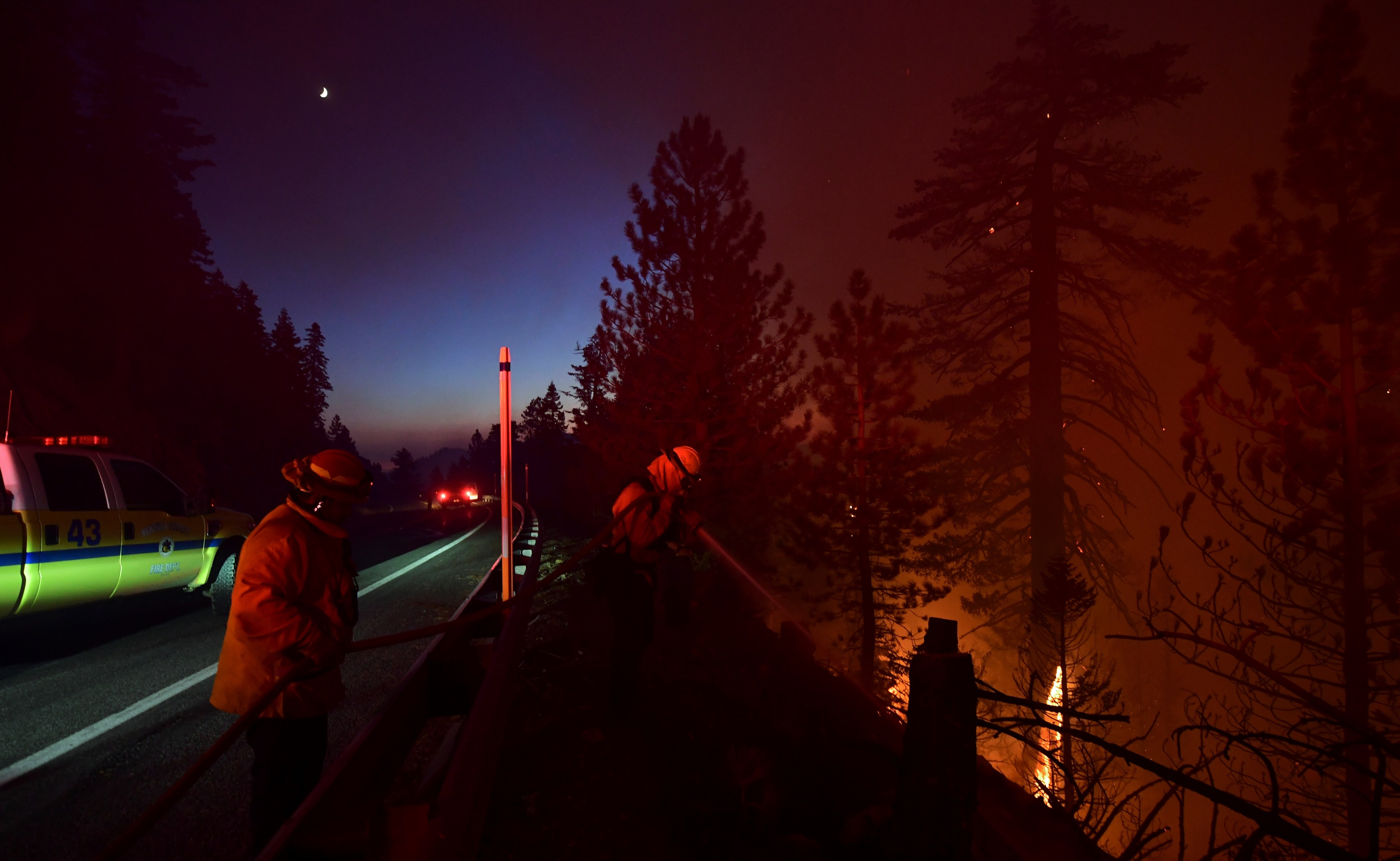 Firefighters work the Bobcat Fire in the Angeles National Forest near Los Angeles, California on Sept. 21, 2020. (FREDERIC J. BROWN/AFP via Getty Images)