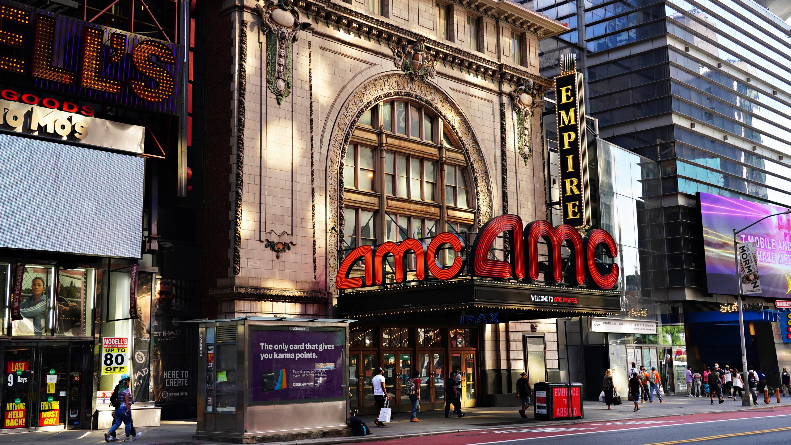 People wearing protective masks walk near AMC Empire 25 as the city continues Phase 4 of reopening following restrictions imposed to slow the spread of coronavirus on Aug. 21, 2020 in New York City. (Cindy Ord/Getty Images)