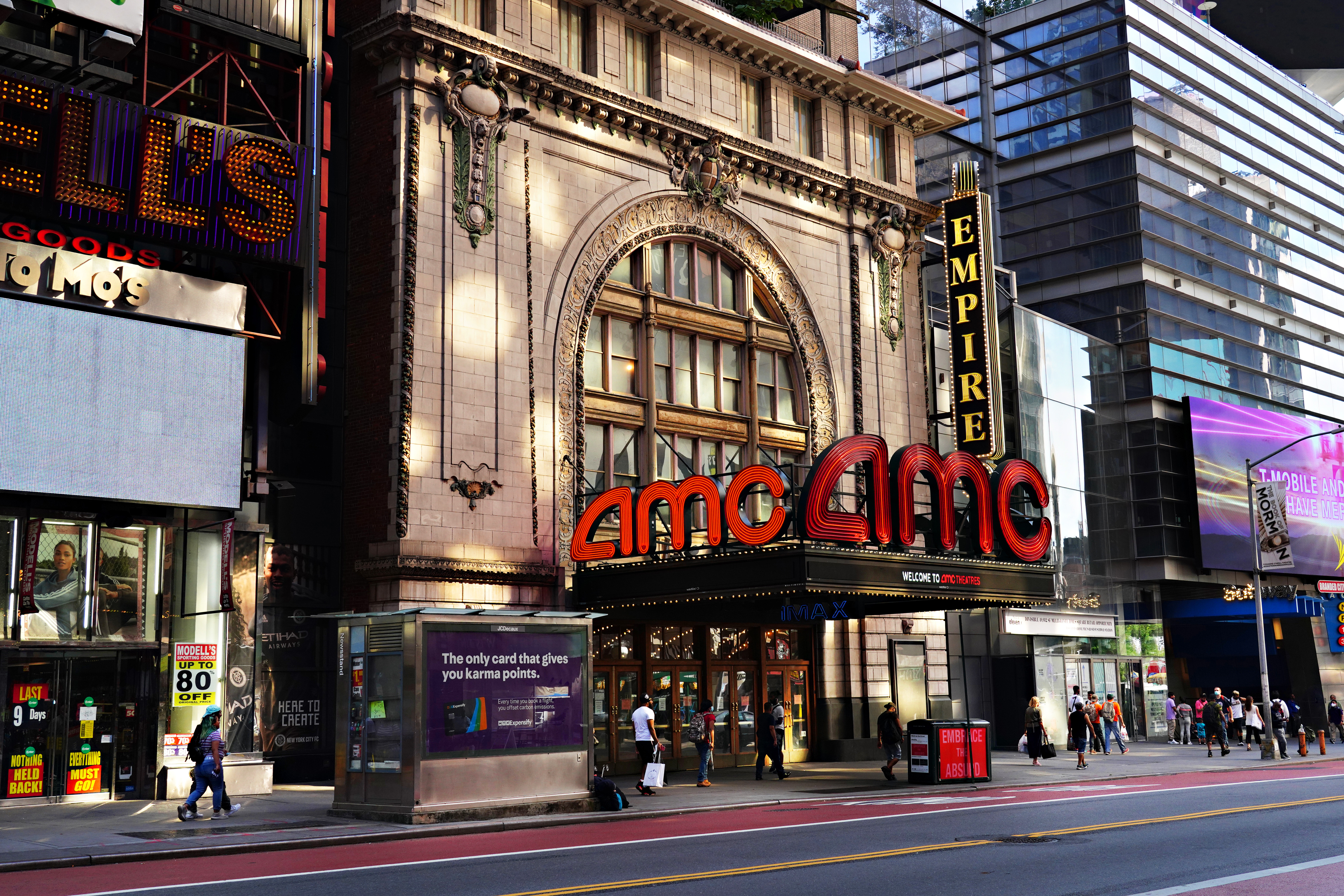 People wearing protective masks walk near AMC Empire 25 as the city continues Phase 4 of reopening following restrictions imposed to slow the spread of coronavirus on Aug. 21, 2020 in New York City. (Cindy Ord/Getty Images)