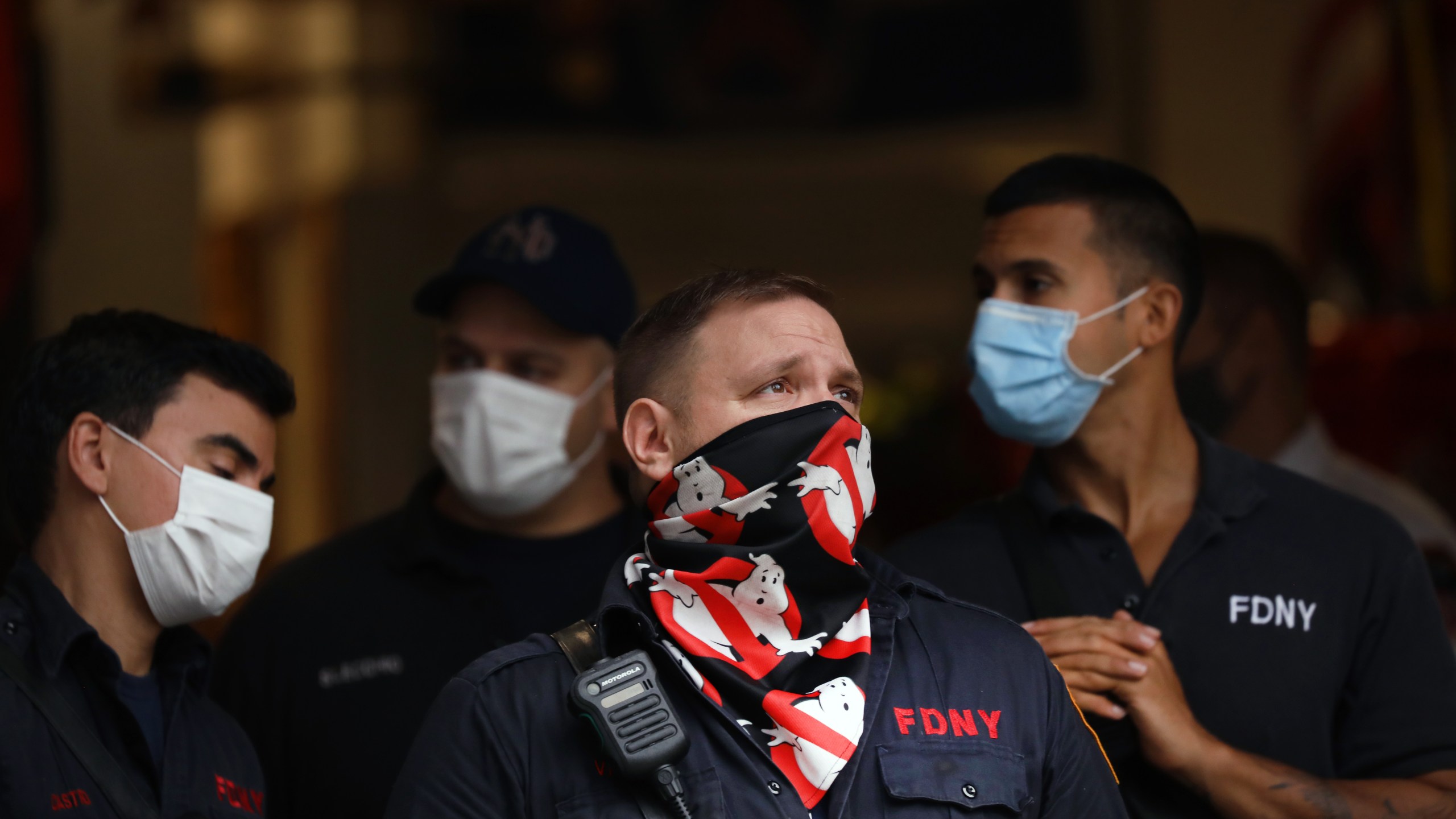 A New York City firefighter gazes up at One World Trade Center, the Freedom Tower, which stands at Ground Zero in lower Manhattan as people prepare to commemorate the September 11, 2001 terror attacks on September 11, 2020 in New York City. (Spencer Platt/Getty Images)