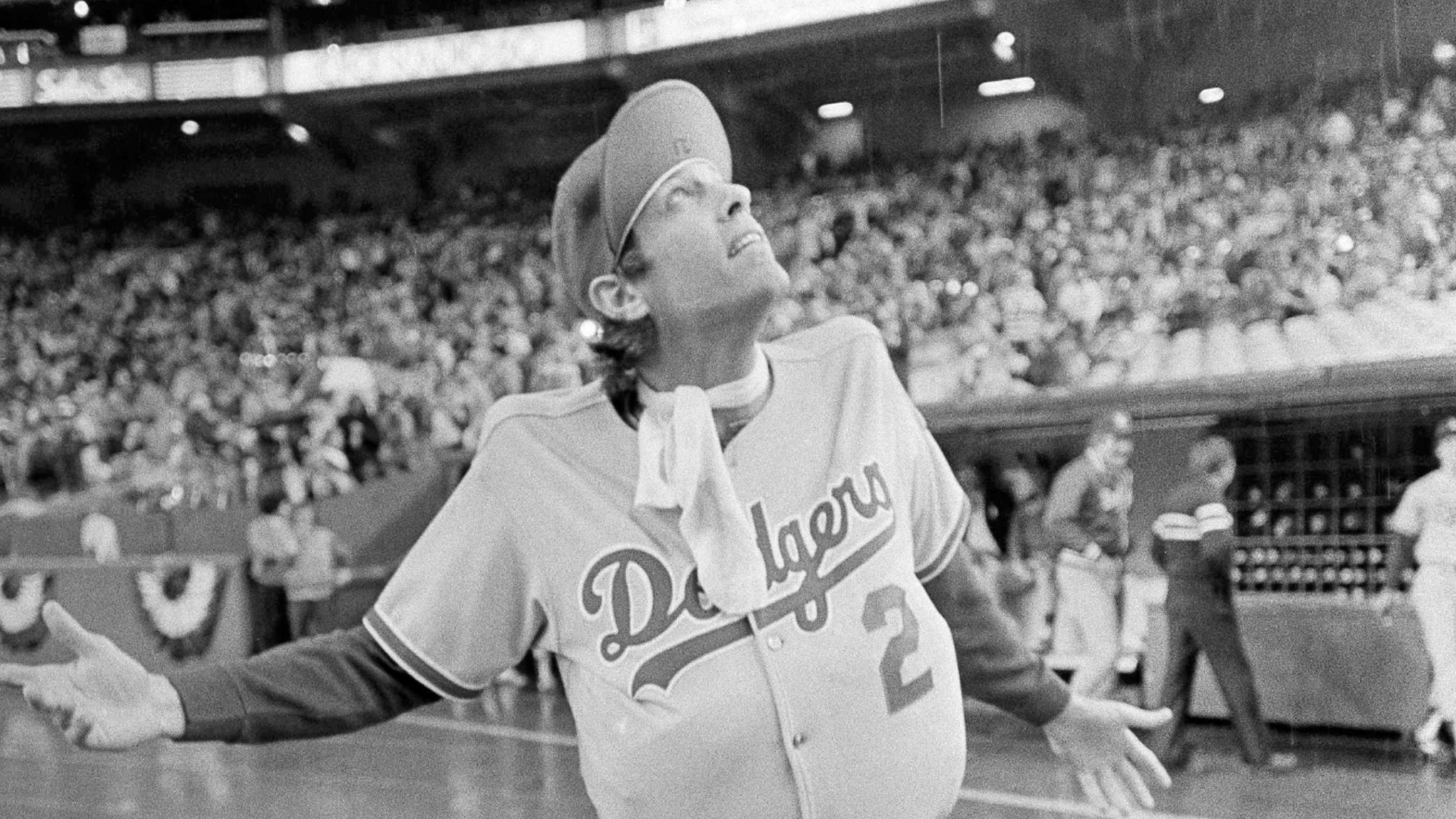 In this Oct. 18, 1981, file photo, Los Angeles Dodgers outfielder Jay Johnstone, wearing a padded version of manager Tommy Lasorda's uniform, checks the progress of a rain delay before a National League Playoff baseball game with the Expos in Montreal. Johnstone, who won World Series championships as a versatile outfielder with the New York Yankees and Los Angeles Dodgers while being baseball’s merry prankster, died Saturday, Sept. 26, of complications from COVID-19 at a nursing home in Granada Hills, Calif., his daughter Mary Jayne Sarah Johnstone said Monday, Sept. 28, 2020. He was 74. He also from dementia in recent years, his daughter said. (AP Photo/Barrett, File)