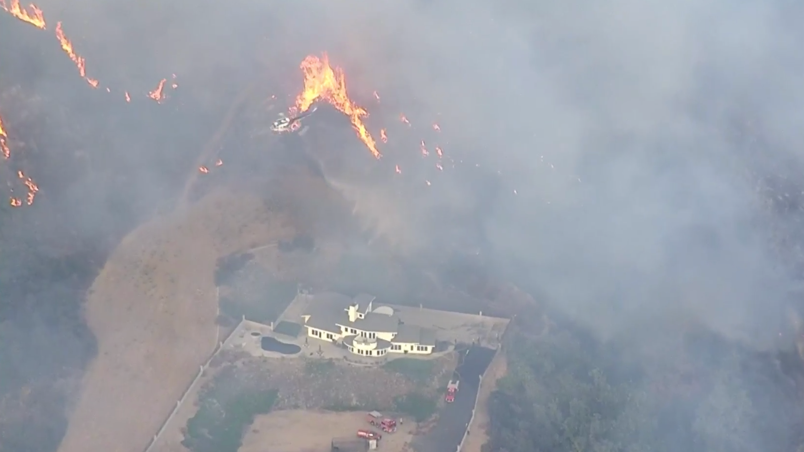 The El Dorado Fire burns near a structure in the Yucaipa area on Sept. 5, 2020. (KTLA)