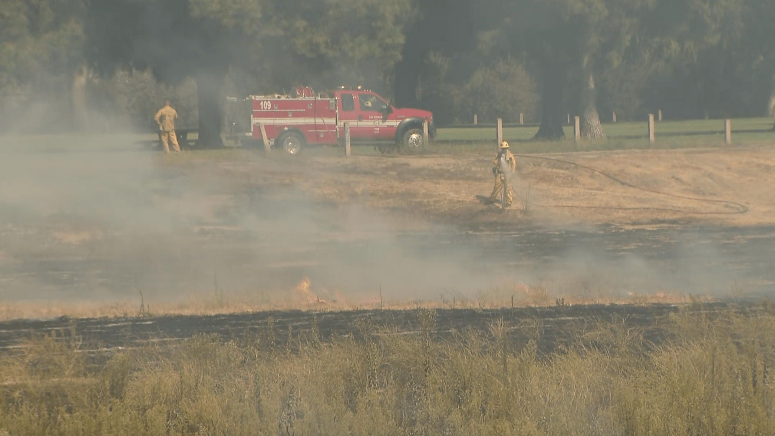 Firefighters battle a brush fire in the Sepulveda Basin on Sept. 7, 2020. (KTLA)