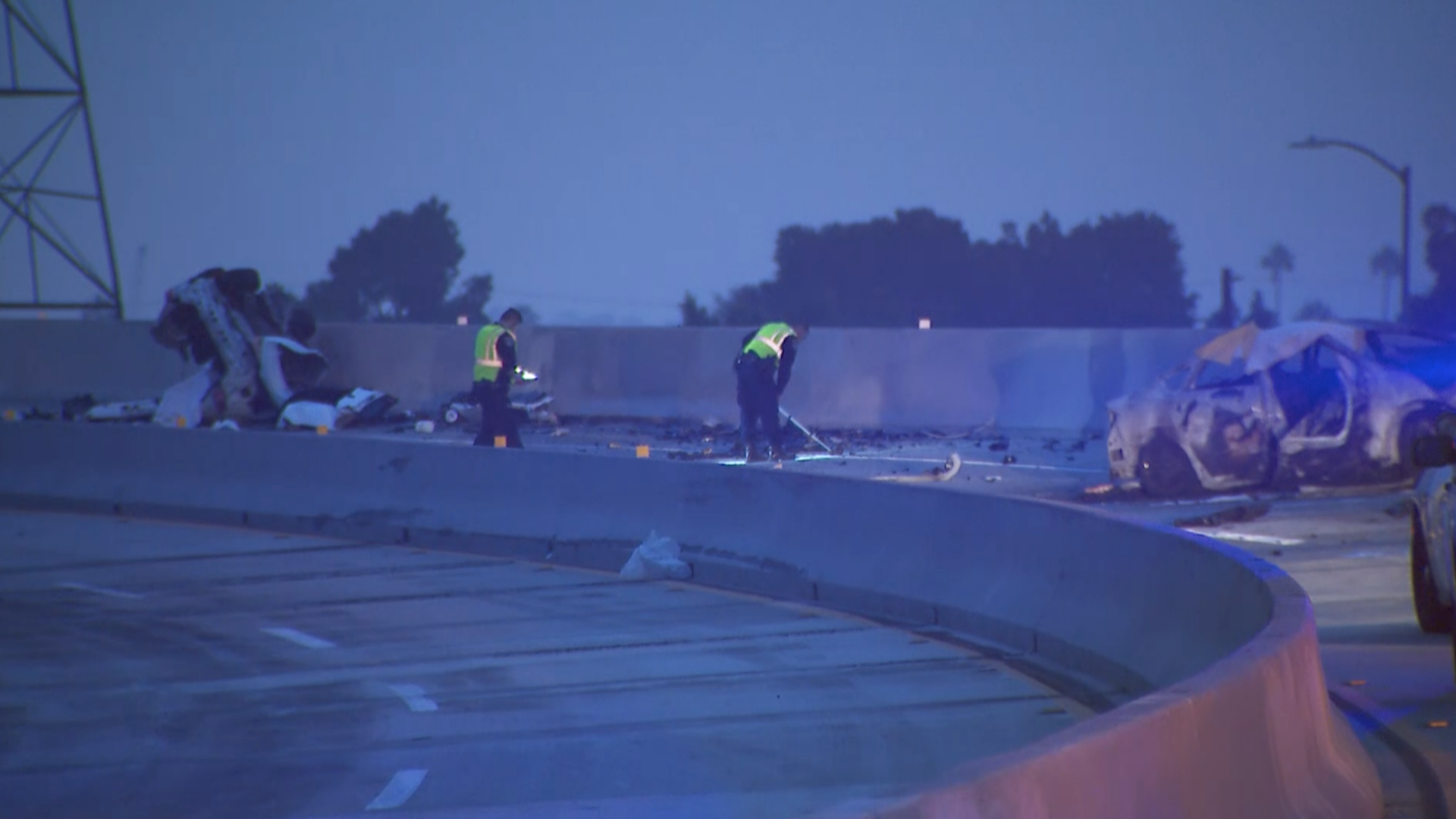 Crews clean up the scene of a deadly crash on the northbound 110 Freeway in the Harbor Gateway area on Sept. 12, 2020. (KTLA)