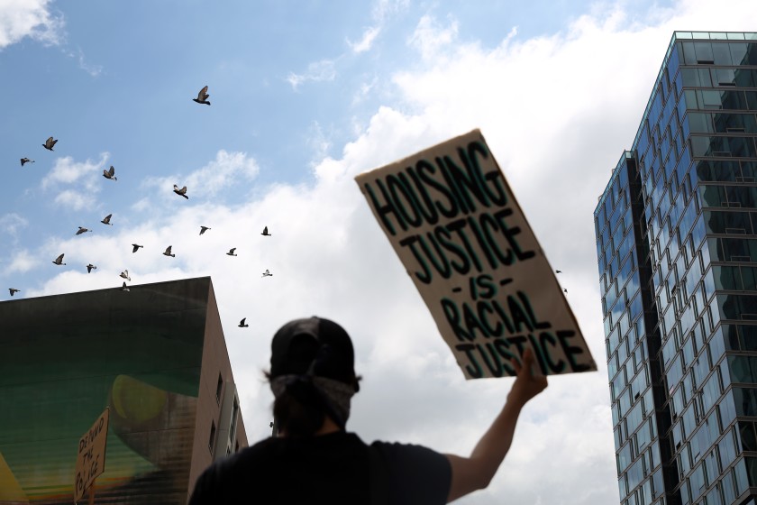 A protester marches with the L.A. Tenants Union in downtown Los Angeles calling for rent cancellation, protections against landlord harassment and shelter for homeless people in June.(Dania Maxwell / Los Angeles Times)