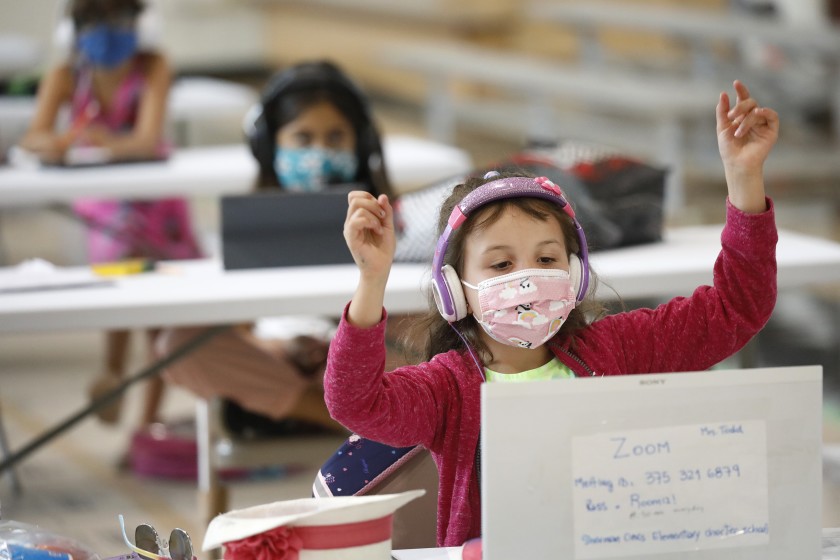 First-grader April Alvarez enjoys an online class from her desk at the Delano Recreation Center in Van Nuys, one of L.A.'s Safer at Parks: Alternative Learning Centers.(Al Seib / Los Angeles Times)