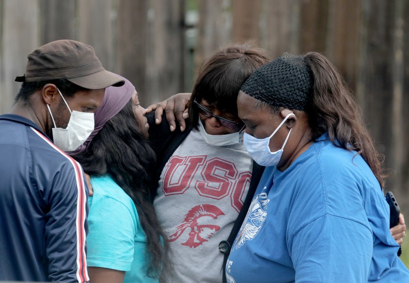 Relatives and friends of Dijon Kizzee gather at the site where Kizzee was killed. Recently, there’s been a string of violence in the South L.A. neighborhood of Westmont that has left four men dead from gunshots.(Luis Sinco / Los Angeles Times)