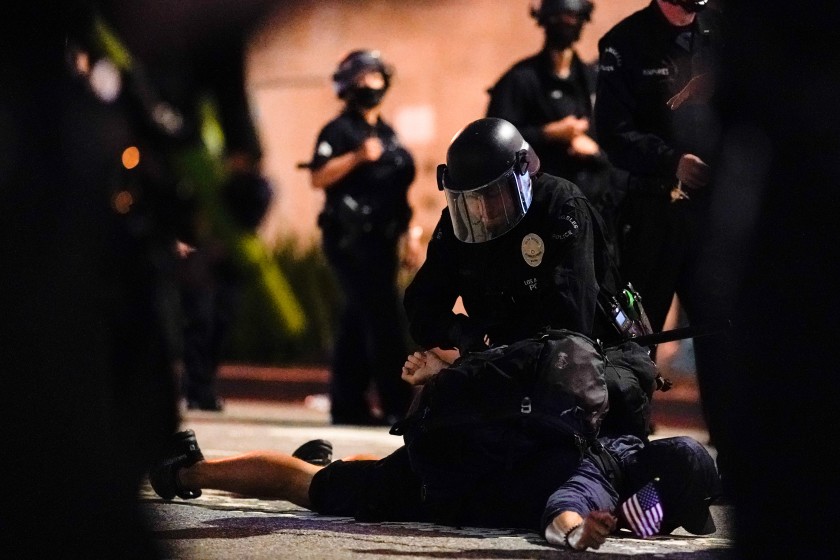 A protester is detained in Los Angeles in late May.(Kent Nishimura / Los Angeles Times)