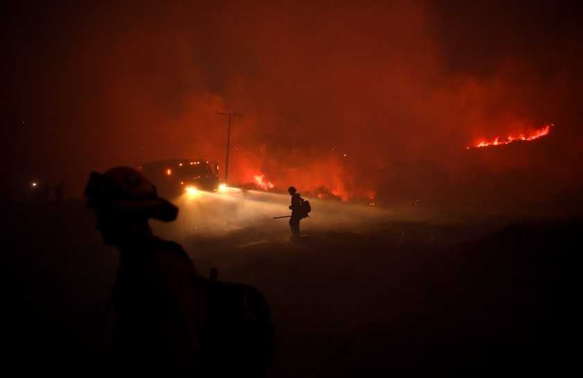 Firefighters put out embers from the El Dorado fire earlier this month.(Wally Skalij / Los Angeles Times)