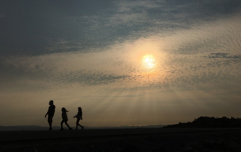 Smoke from nearby brush fires obscures the sun along the Hansen Dam on Sept. 17, 2020.(Myung J. Chun / Los Angeles Times)