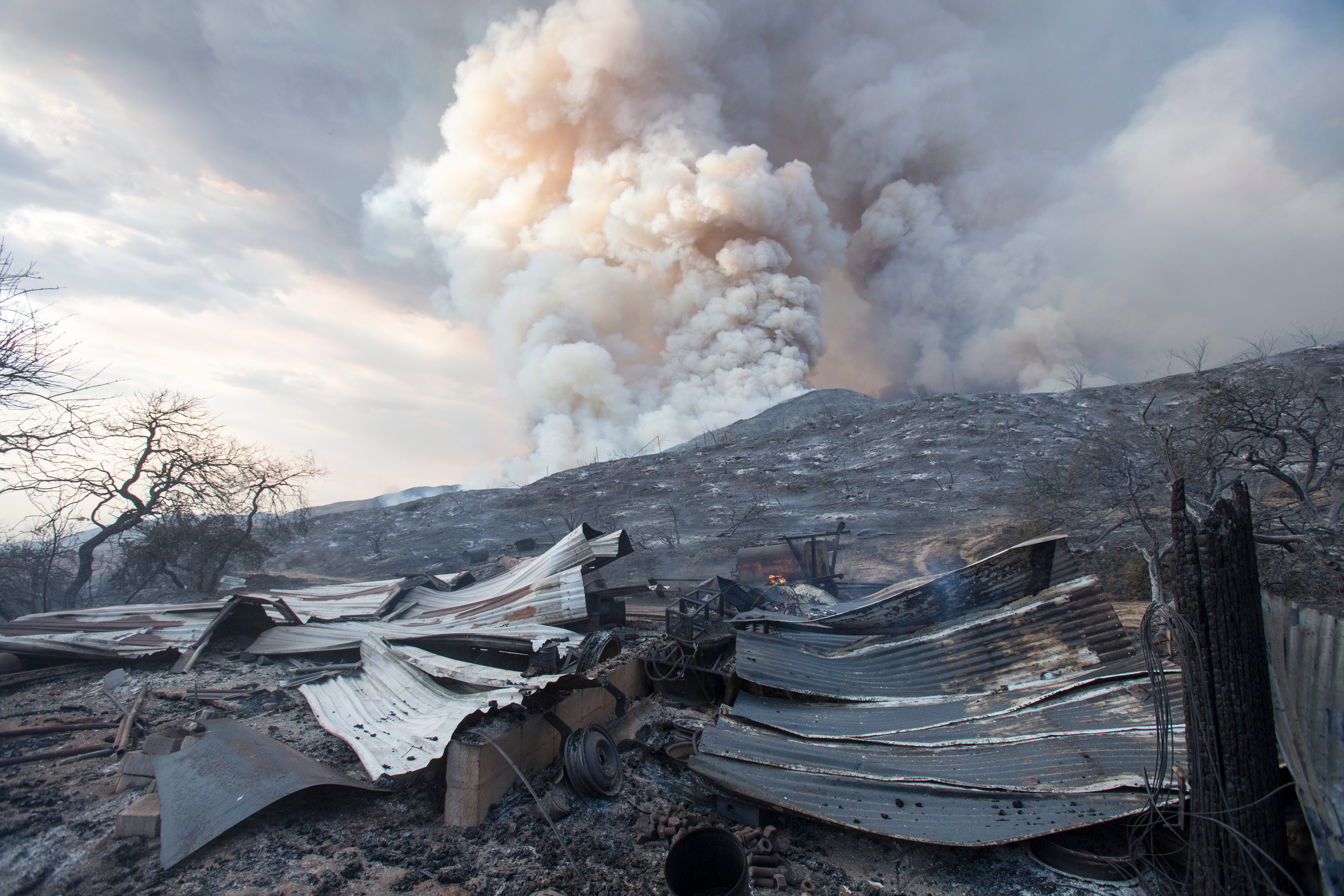 In this Saturday, Sept. 5, 2020, file photo, a burned structure is seen at a wildfire in Yucaipa, Calif. A couple’s plan to reveal their baby’s gender at a party went up in smoke Saturday at El Rancho Dorado Park in Yucaipa, when a pyrotechnical device they used sparked a wildfire that has burned thousands of acres. (AP Photo/Ringo H.W. Chiu, File)