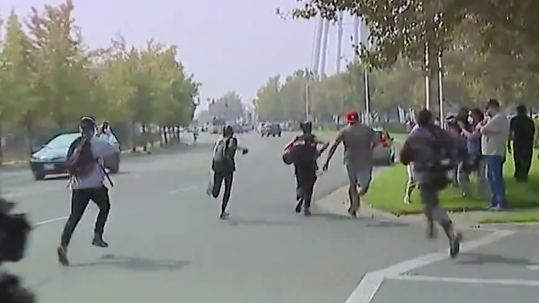 Protesters chase after a car after it swerved into a group of people near McClellan Air Force Base during a visit from President Donald Trump on Sept. 14, 2020. (KTXL)