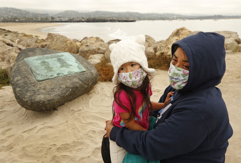 Yadira Alvarez-Peterson holds her 3-year-old daughter, Renata Alvarez-Peterson, while talking about her 16-year-old daughter Berenice Felipe, who was one of the 34 people who died in the Conception boat fire a year ago Wednesday, Sept. 2, 2020. (Al Seib / Los Angeles Times)