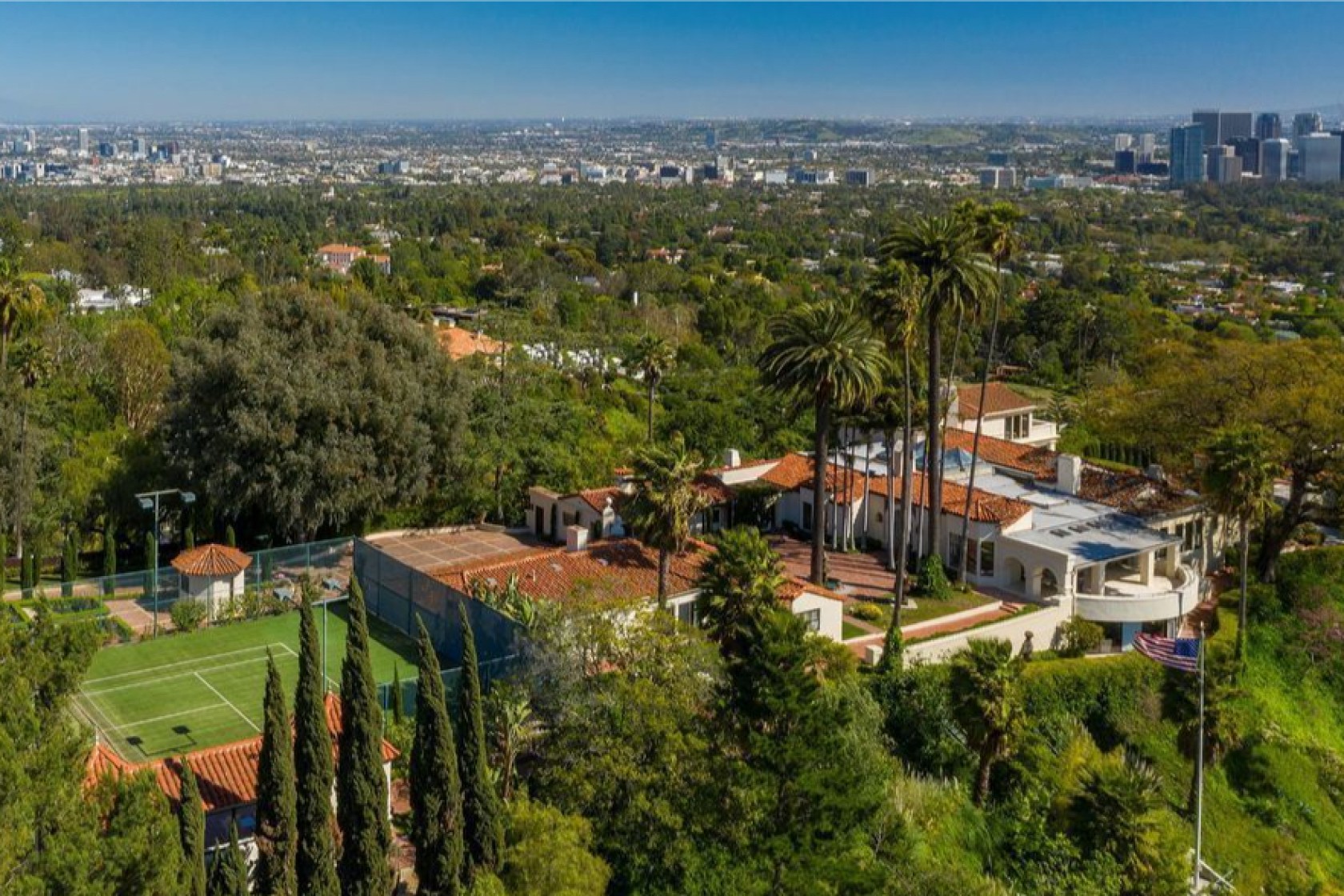 The 2.5-acre site includes a 1930s home, two guesthouses, a screening room, swimming pool and tennis court. (Realtor.com via Los Angeles Times)