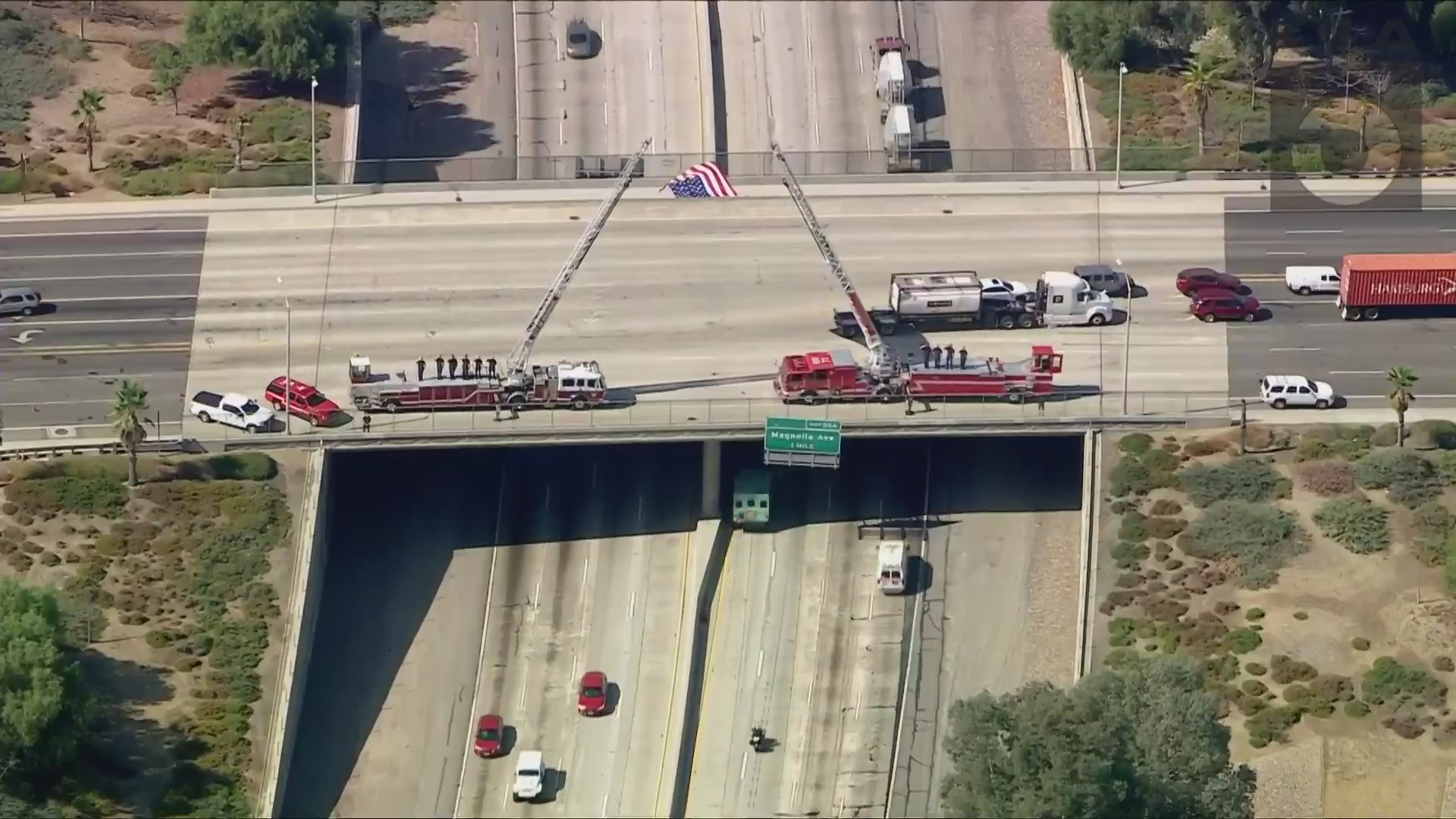 Firefighters salute as a procession for Charles Morton passes on Sept. 22, 2020. (KTLA)