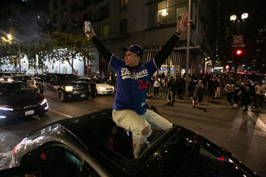 Fans celebrate after the Los Angeles Dodgers defeated the Tampa Bay Rays on Oct. 27, 2020 to win their first World Series since 1988. (Jason Armond / Los Angeles Times)