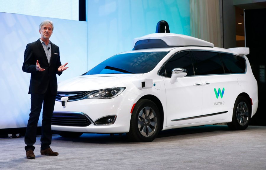 In this Jan. 8, 2017, file photo, John Krafcik, CEO of Waymo, the autonomous vehicle company created by Google's parent company, Alphabet, introduces a Chrysler Pacifica hybrid outfitted with Waymo's own suite of sensors and radar, at the North American International Auto Show in Detroit. (AP Photo/Paul Sancya, File)