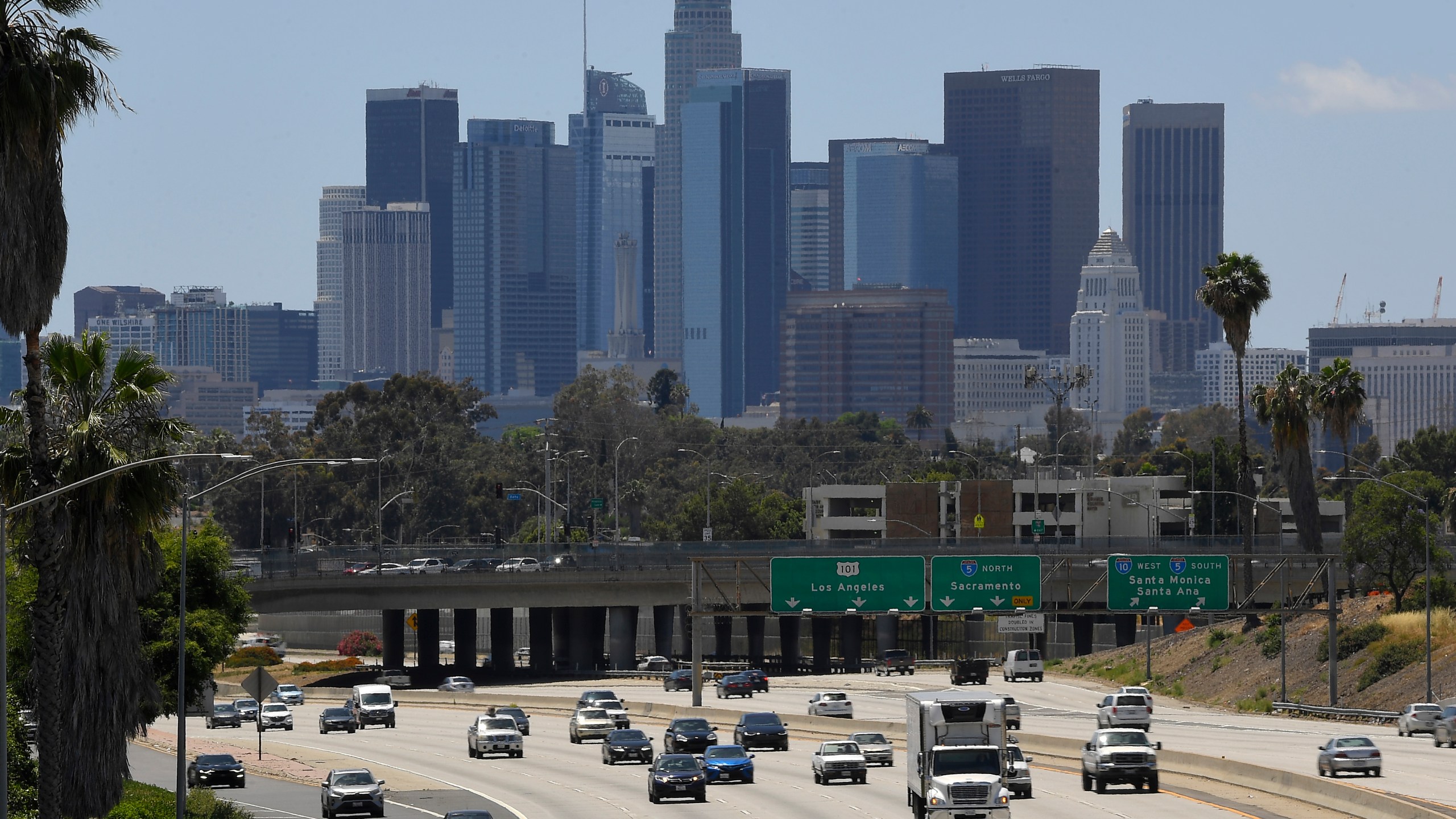 Traffic moves along the 10 Freeway as downtown Los Angeles is seen in the background in Los Angeles on May 19, 2020. (AP Photo/Mark J. Terrill)