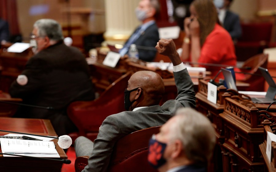 State Sen. Steve Bradford, D-Gardena, center, raises his fist in celebration as the Senate approves a measure to place a proposed Constitutional amendment on the November ballot to overturn its ban on affirmative action programs, at the Capitol, in Sacramento, June 24, 2020. (AP Photo/Rich Pedroncelli)