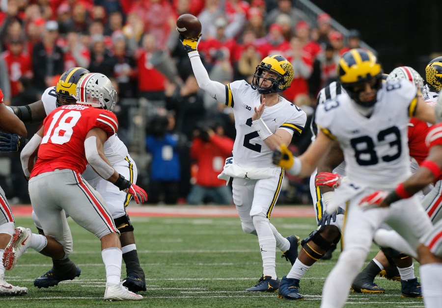 In this Nov. 24, 2018, file photo, Michigan quarterback Shea Patterson throws a pass against Ohio State during an NCAA college football game in Columbus, Ohio. Magistrate Judge Norah McCann King moved a change of plea hearing from June 18 to July 1, 2020, for Daniel Rippy. Rippy is accused of making an "electronic communication" threat from California during this game between Ohio State and the University of Michigan threatening a shooting and vowing to hurt players on the football team. (AP Photo/Jay LaPrete)