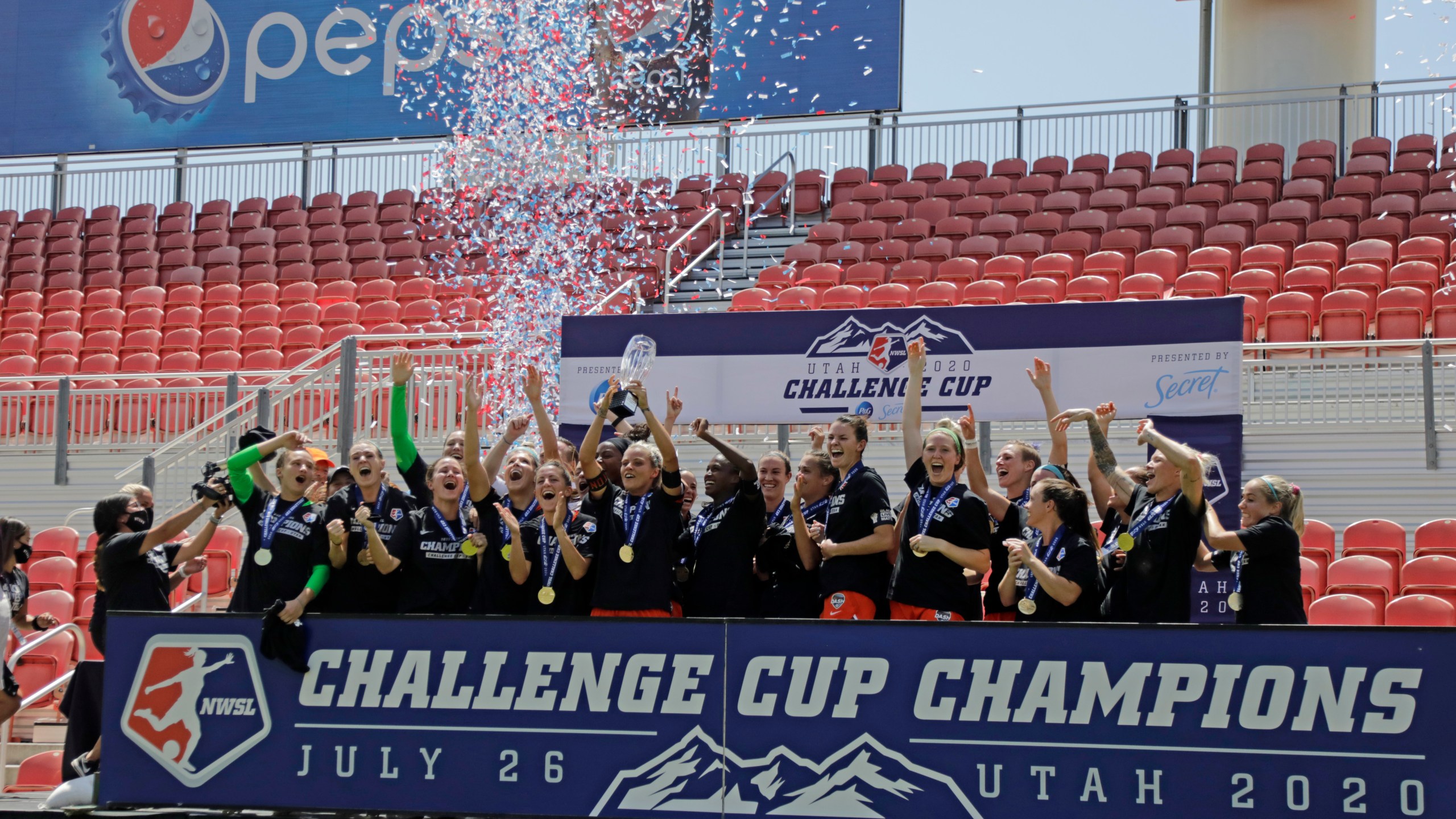 Houston Dash's Rachel Daly hoists the trophy with teammates after defeating the Chicago Red Stars to win the championship soccer game of the NWSL Challenge Cup Sunday, July 26, 2020, in Sandy, Utah. The Angel City Football Club will begin NWSL play in 2022. (AP Photo/Rick Bowmer)