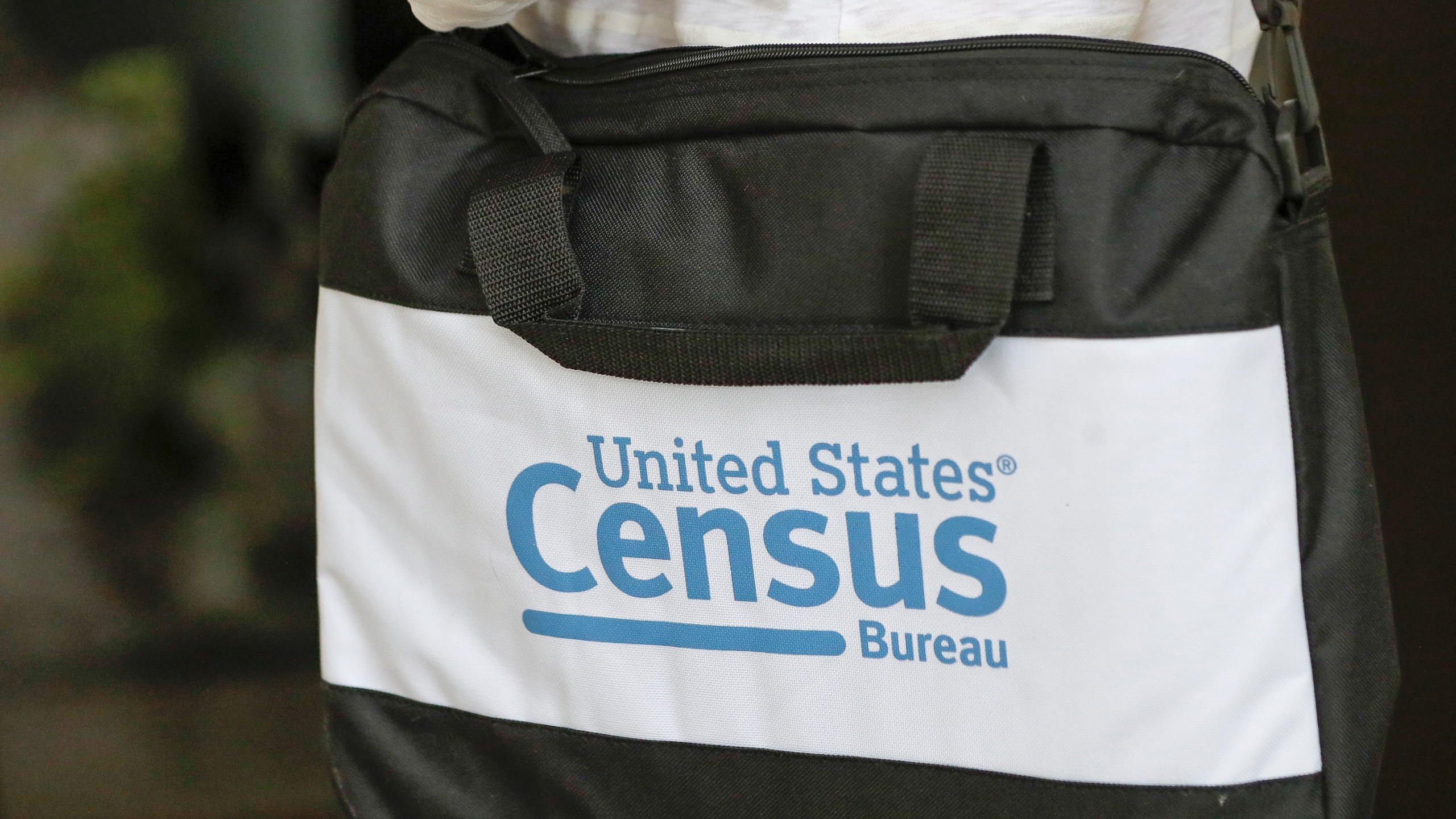 A briefcase of a census taker is seen as she knocks on the door of a residence on Aug. 11, 2020, in Winter Park, Fla. (John Raoux/Associated Press)