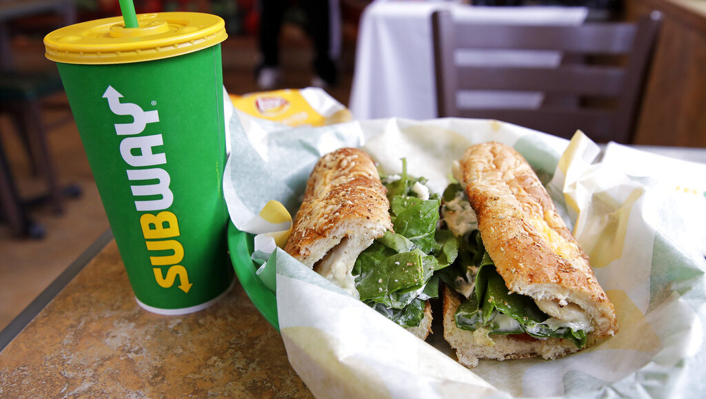 In this Feb. 23, 2018 file photo, a sandwich and a Subway soft drink cup are seen at a restaurant in Londonderry. (AP Photo/Charles Krupa, File)