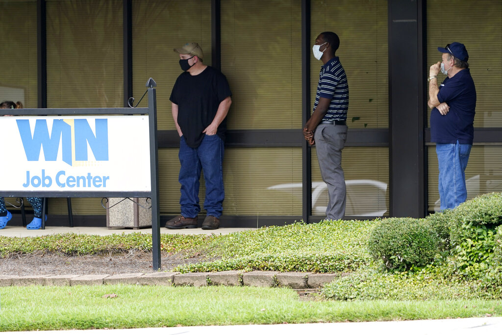 In this Aug. 31, 2020, file photo, clients line up outside the Mississippi Department of Employment Security WIN Job Center in Pearl, Miss. (AP Photo/Rogelio V. Solis, File)