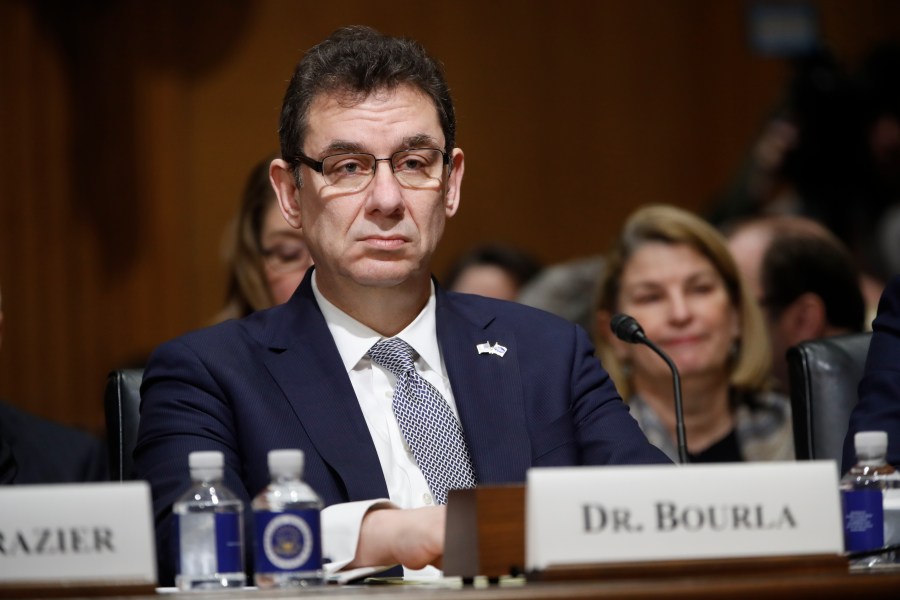 In this Tuesday, Feb. 26, 2019 file photo, Albert Bourla, chief executive officer of Pfizer, prepares to testify before the Senate Finance Committee hearing on drug prices, on Capitol Hill in Washington. On Thursday, Oct. 1, 2020, Bourla wrote to Pfizer employees that he's “disappointed” the timing for a vaccine to be available was politicized during Tuesday night’s presidential debate, saying the company won’t succumb to political pressure. (AP Photo/Pablo Martinez Monsivais)