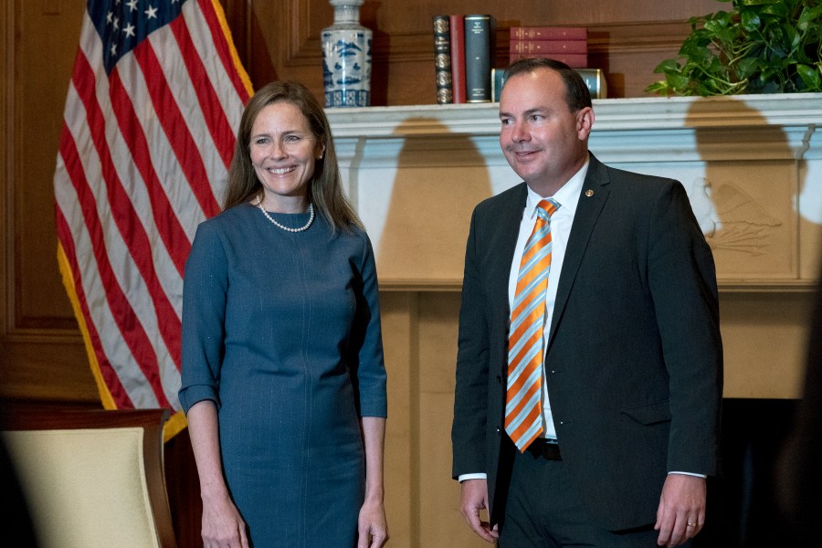 In this Sept. 29, 2020, photo, Judge Amy Coney Barrett, President Donald Trump's nominee to the Supreme Court, poses with Sen. Mike Lee, R-Utah, both without masks, at the Capitol in Washington. (Stefani Reynolds/Pool via AP, File)