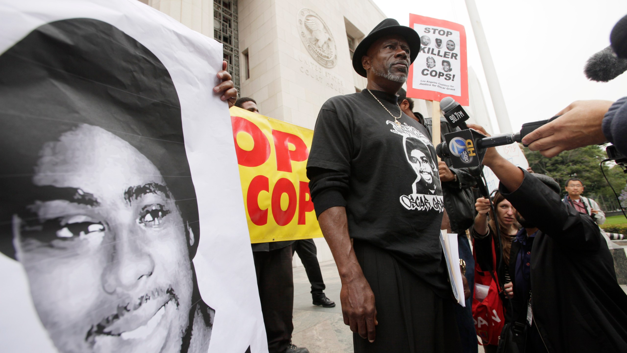 In this June 13, 2011, file photo, Cephus "Bobby" Johnson stands on the steps of the U.S. District Court building in Los Angeles protesting the release of Johannes Mehserle, the former San Francisco Bay Area transit officer who fatally shot Johnson's nephew Oscar Grant. (Nick Ut/Associated Press)