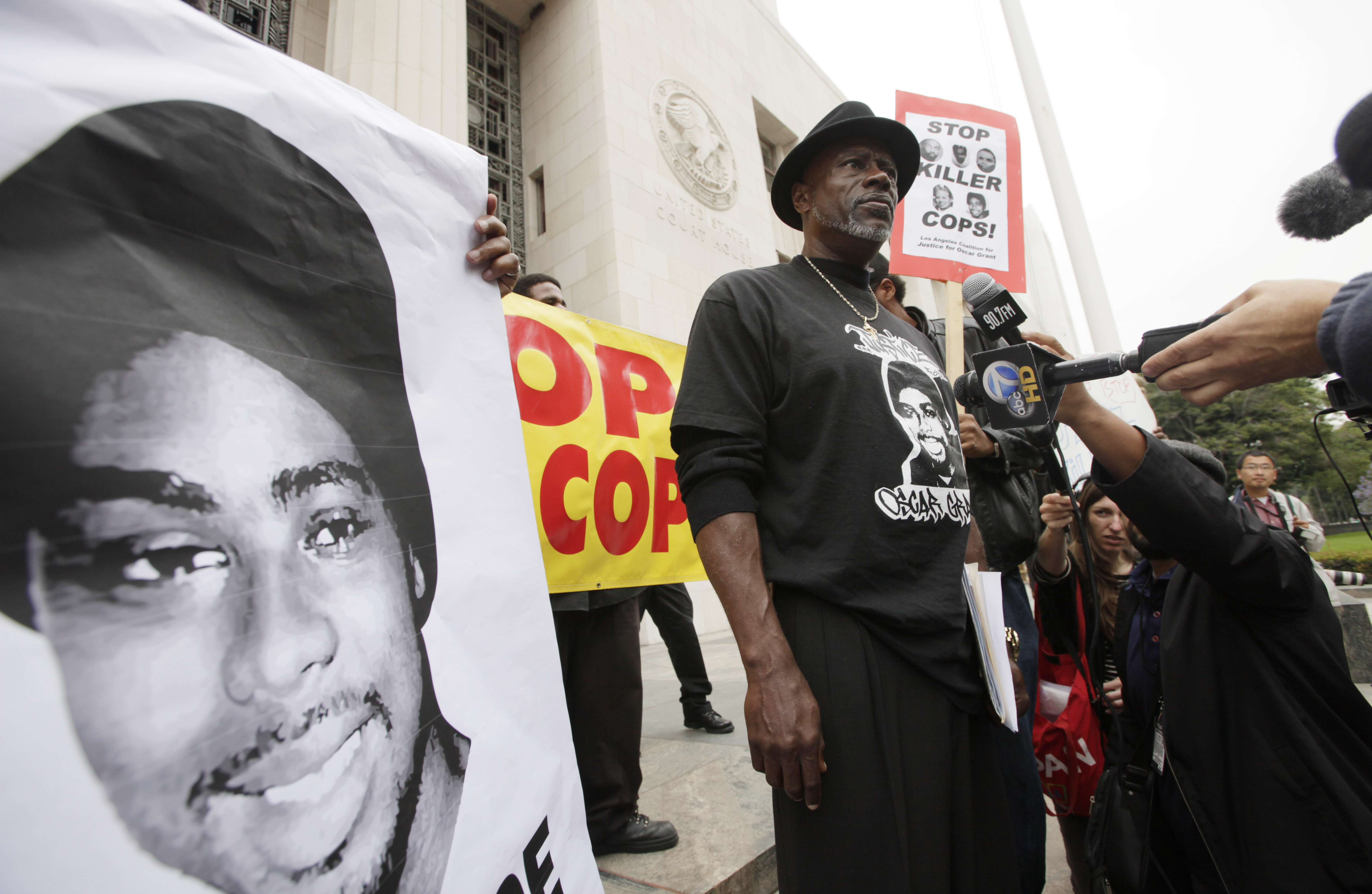 In this June 13, 2011, file photo, Cephus "Bobby" Johnson stands on the steps of the U.S. District Court building in Los Angeles protesting the release of Johannes Mehserle, the former San Francisco Bay Area transit officer who fatally shot Johnson's nephew Oscar Grant. (Nick Ut/Associated Press)